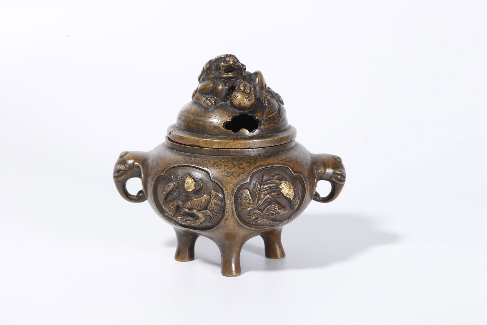 A BRONZE INCENSE BURNER WITH FLORAL MOTIF AND BEAST HANDLES: Bronze Incense Burner with Floral Motif and Beast Handles