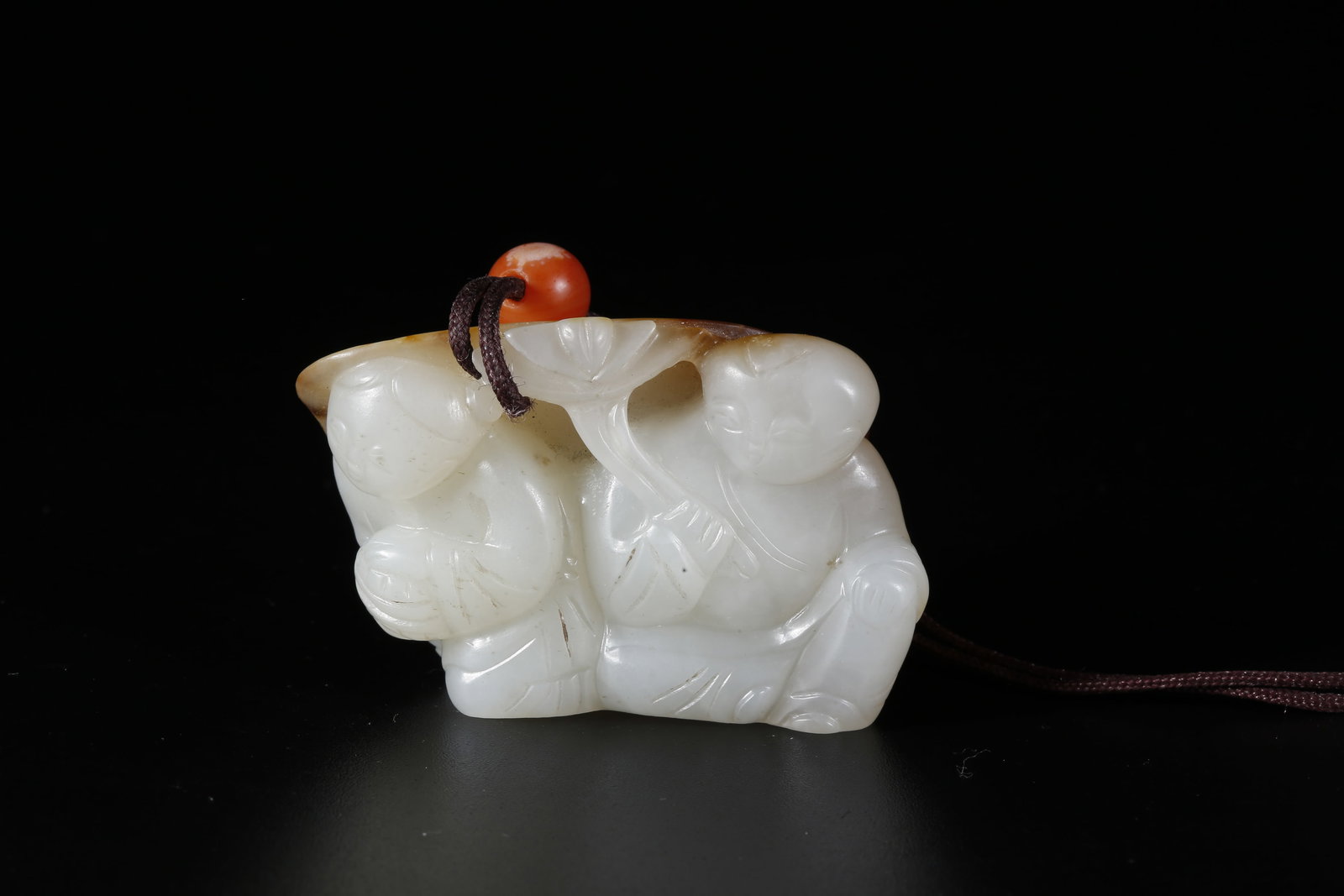 A HETIAN JADE CARVED CHILD-SHAPED PENDANT (1 of 10)