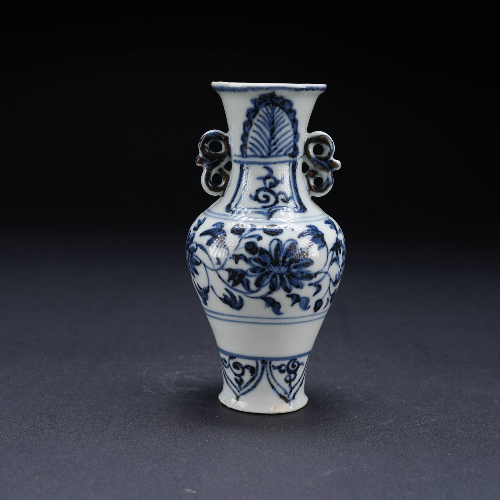 A BLUE AND WHITE VASE WITH INTERTWINED FLORAL PATTERN: Blue and White Vase with Intertwined Floral Pattern