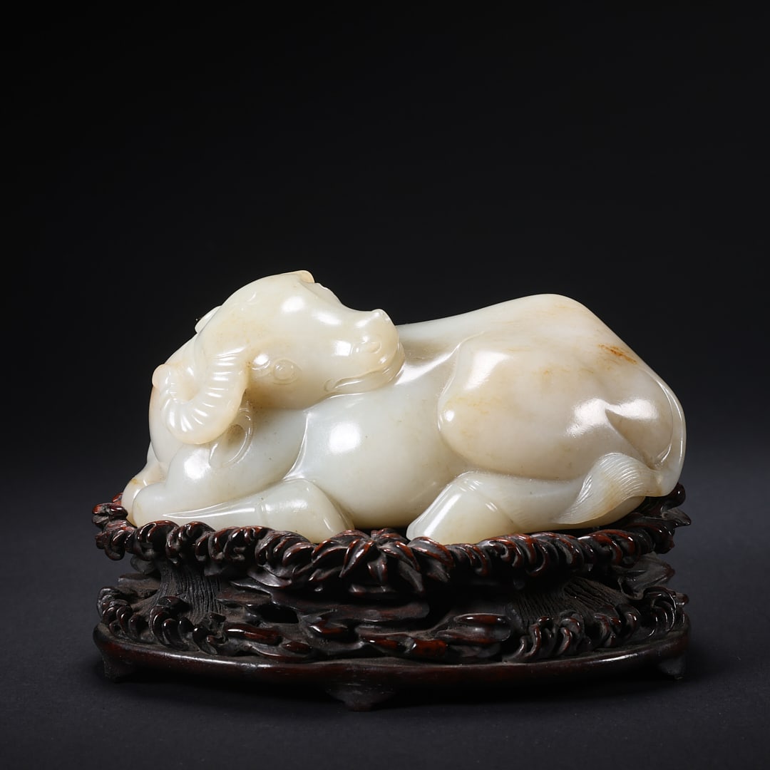 A HETIAN JADE "LEFT-TURNING OX" ON WOODEN BASE (1 of 9)