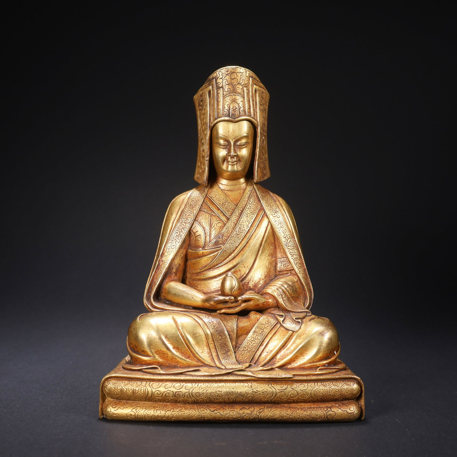 A GILT-COPPER LAMA FIGURE (1 of 9)