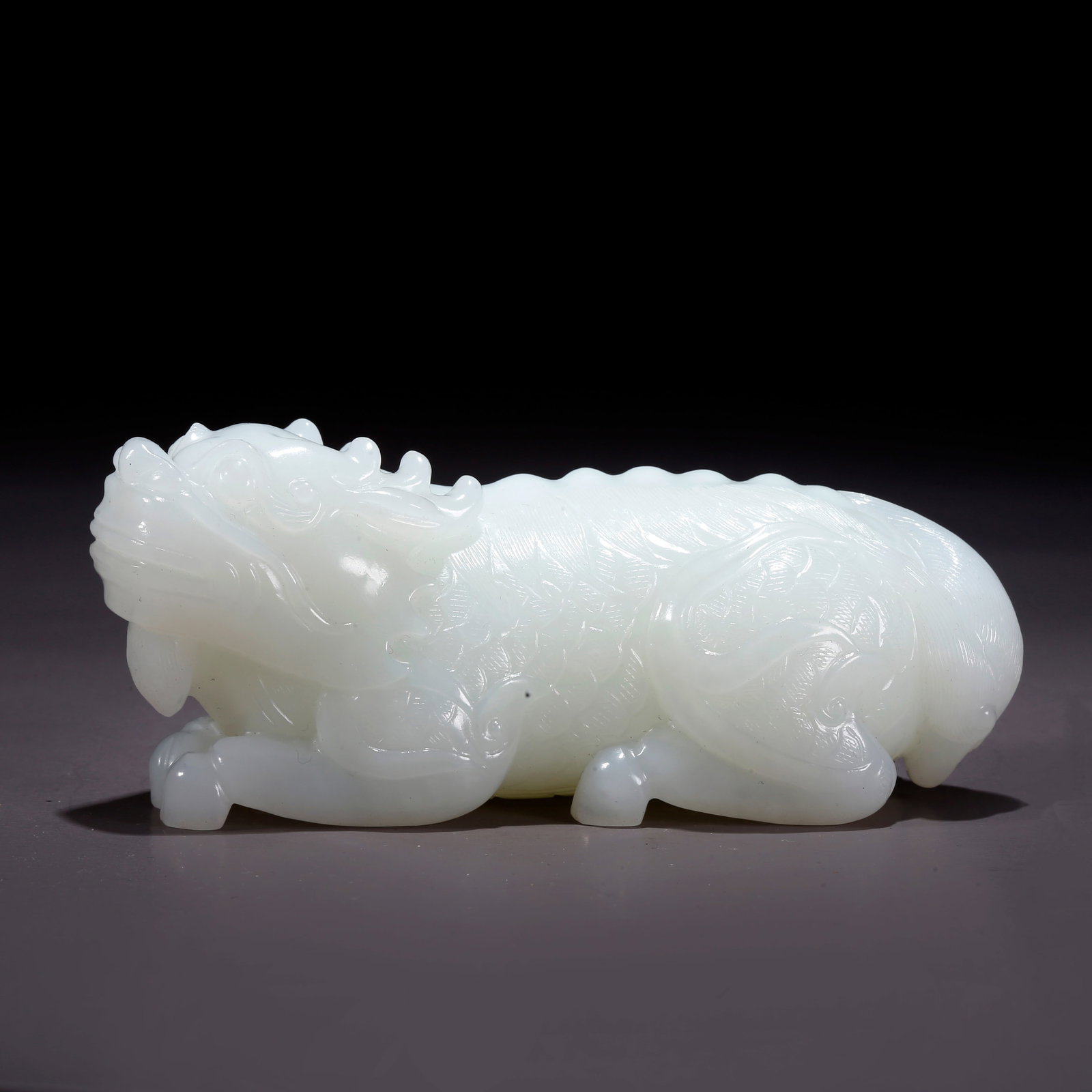 A HETIAN JADE TIGER-SHAPED FIGURINE (1 of 10)