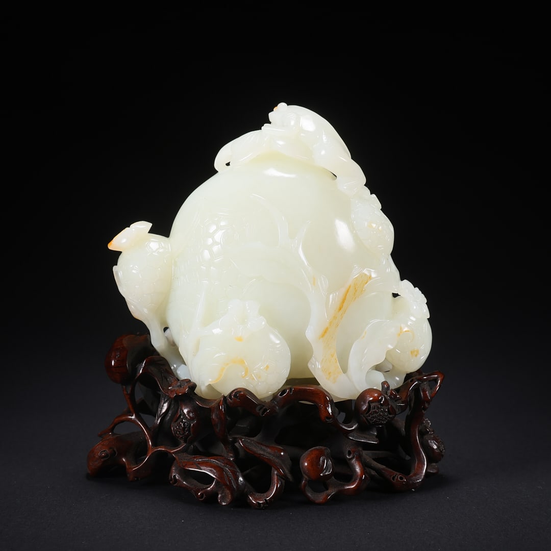 A HETIAN JADE "POMEGRANATE WITH HUNDREDS OF SEEDS" ON WOODEN BASE (1 of 9)