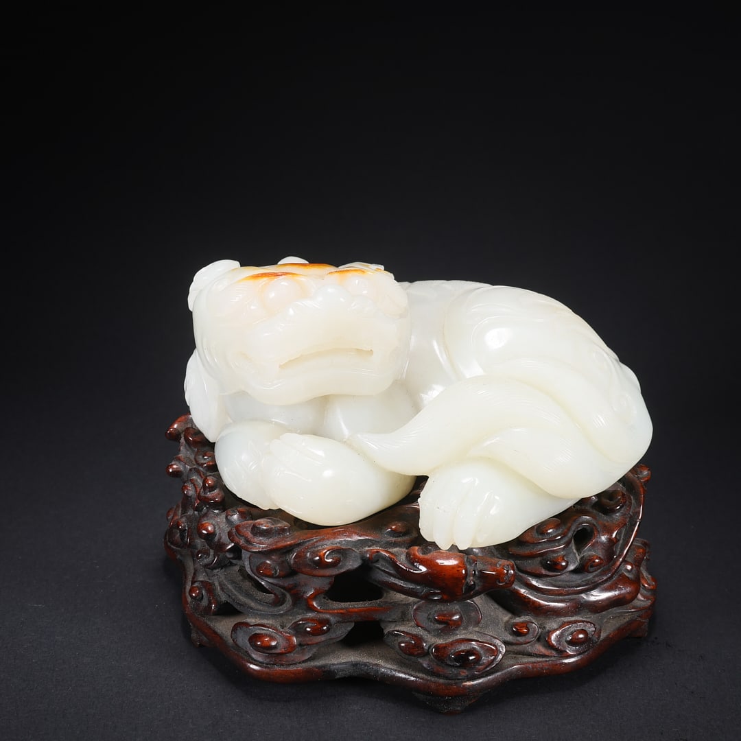 A HETIAN JADE "LEFT-TURNING AUSPICIOUS BEAST" ON WOODEN BASE (1 of 9)