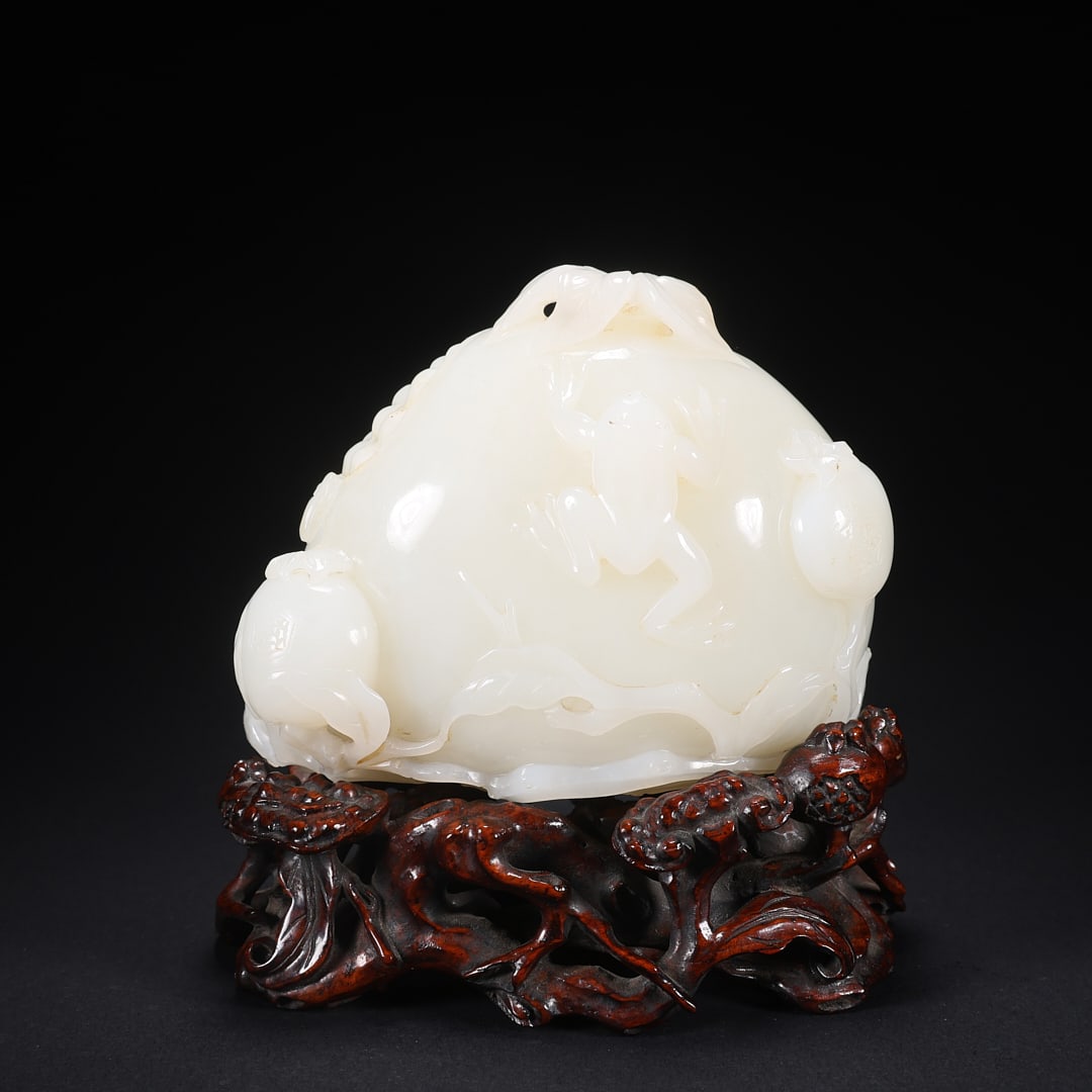 A HETIAN JADE ORNAMENT ON WOODEN BASE WITH MONKEY, FROG, AND POMEGRANATE (1 of 9)
