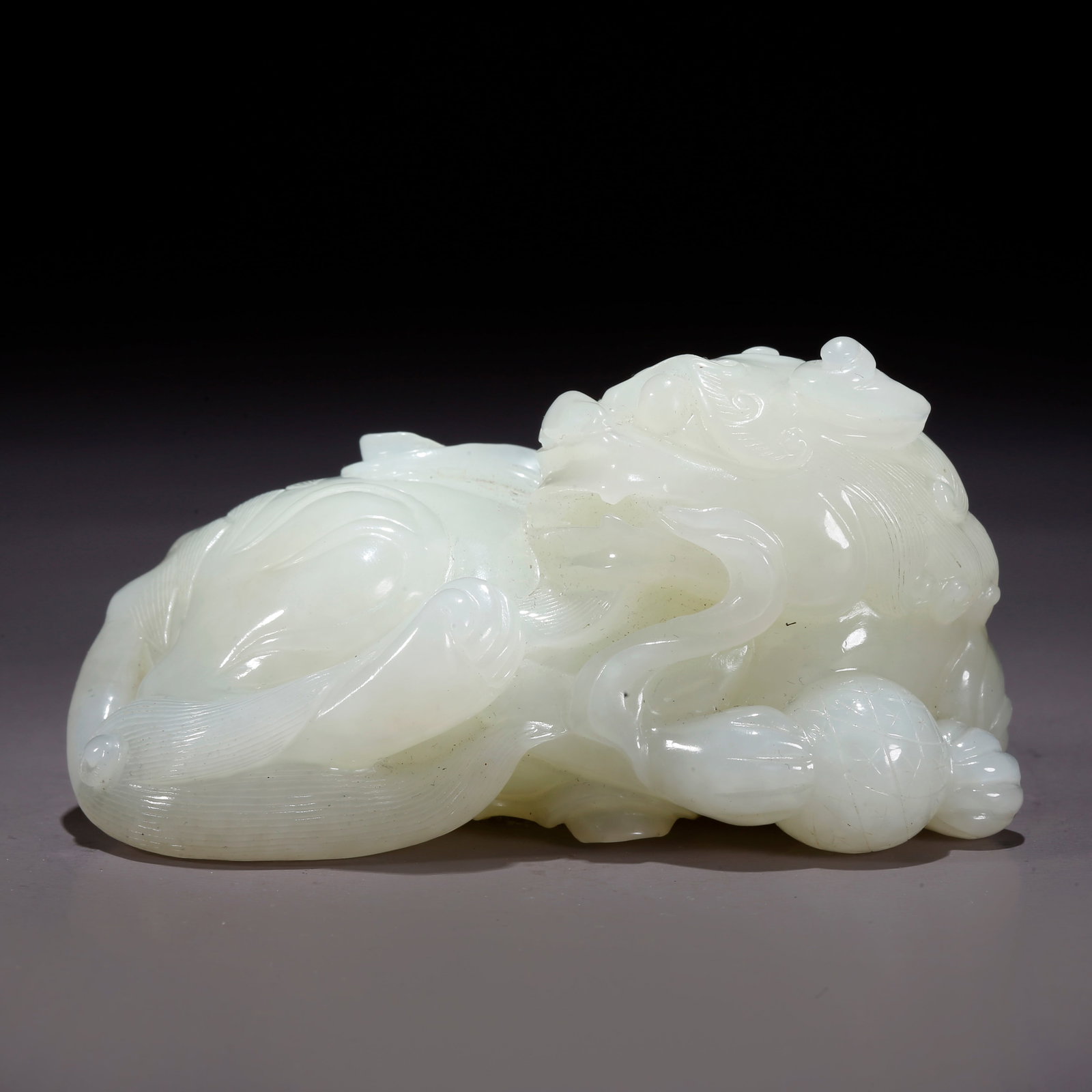 A HETIAN JADE TIGER-SHAPED FIGURINE (1 of 10)
