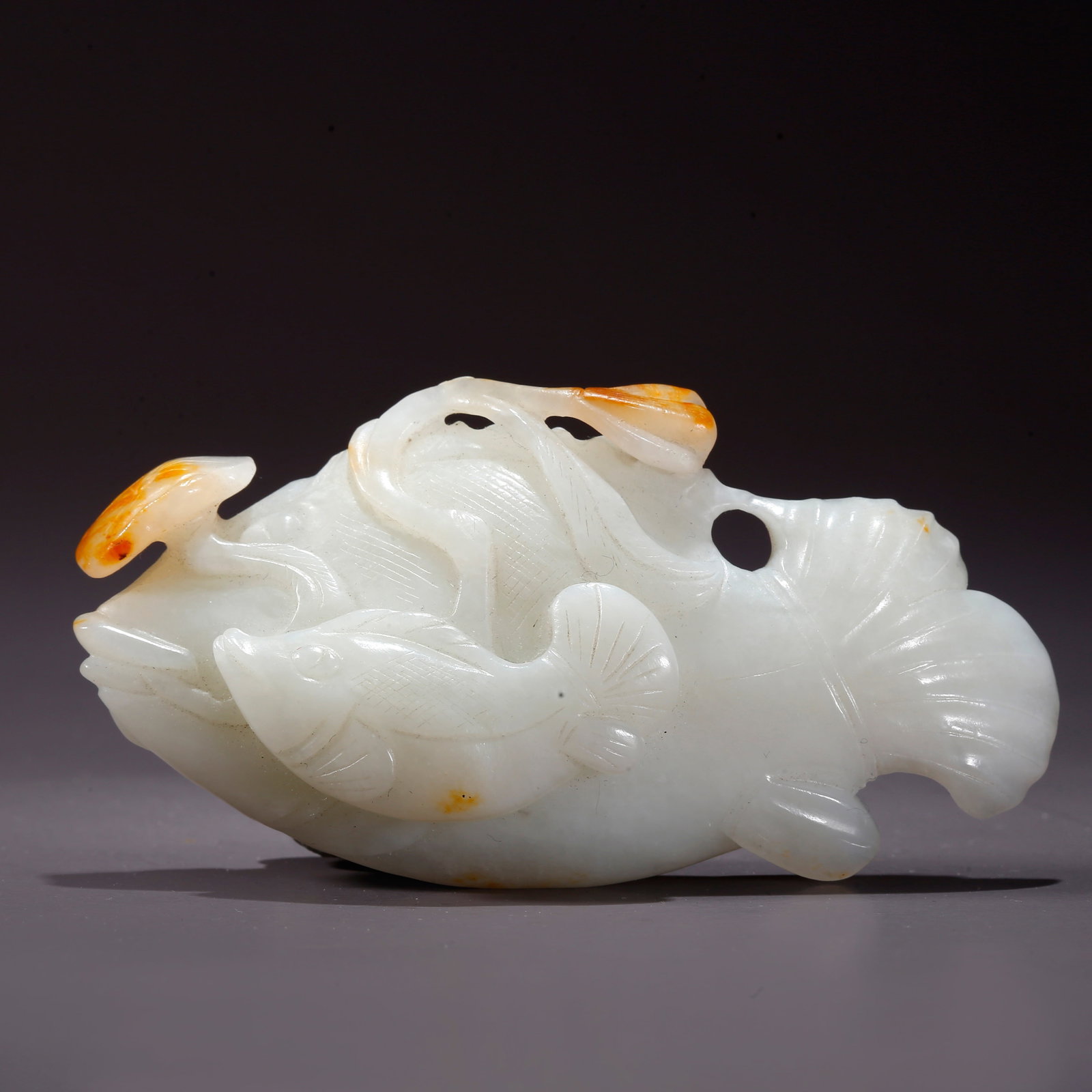 A HETIAN JADE "SURPLUS EVERY YEAR" FIGURINE: Hetian Jade "Surplus Every Year" Figurine