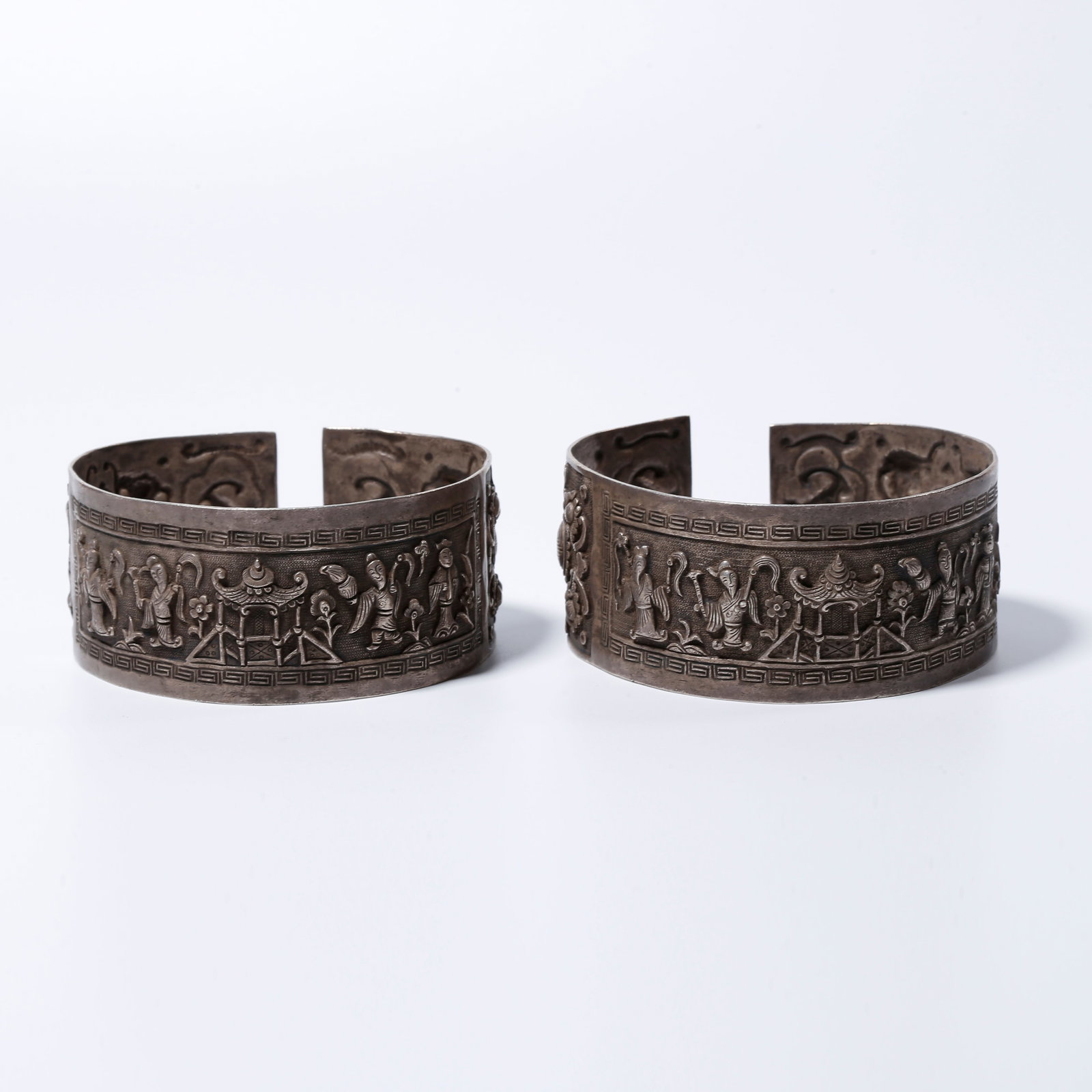 A SILVER PAIR OF EIGHT IMMORTALS PATTERNED BRACELETS (1 of 9)
