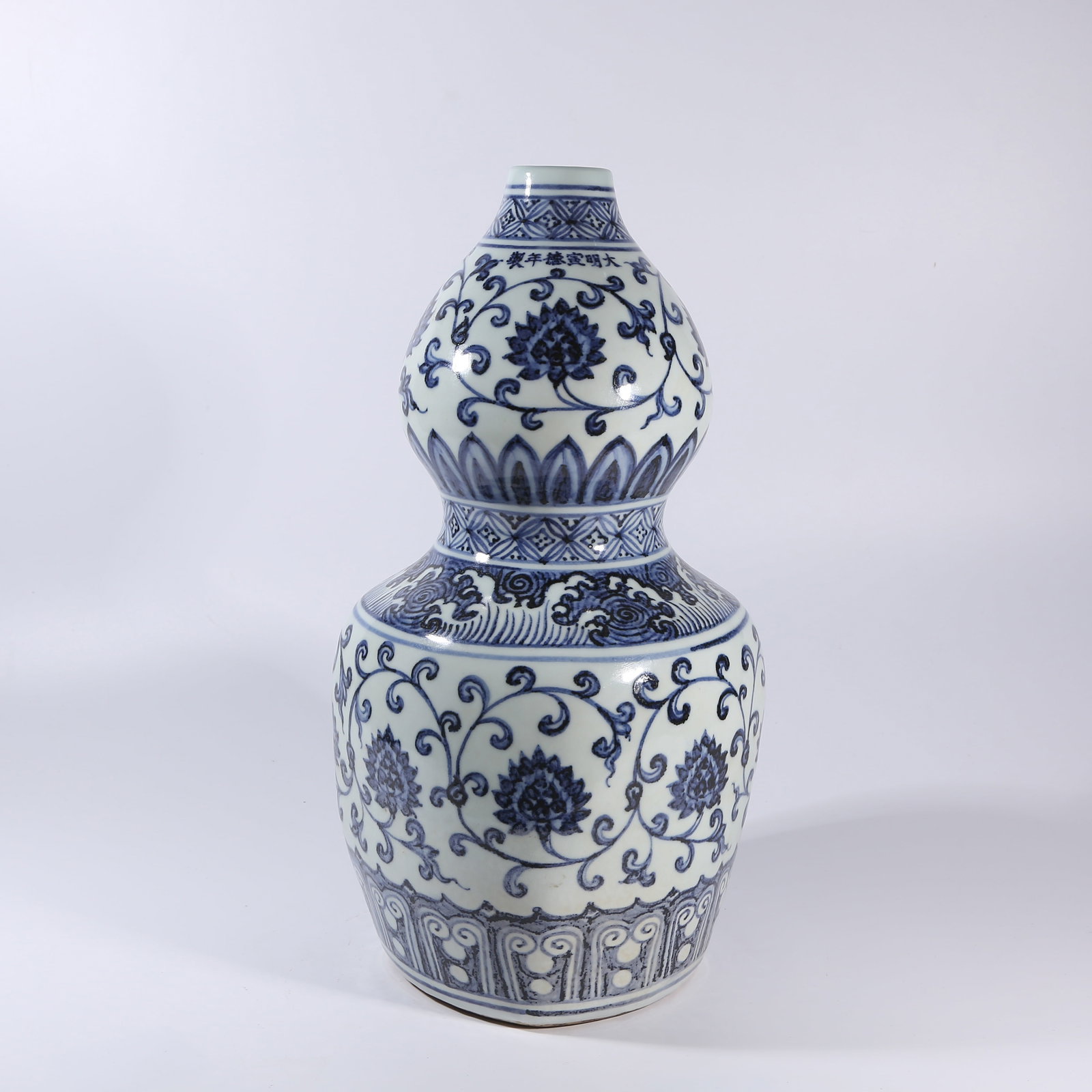 A BLUE-AND-WHITE GOURD-SHAPED VASE IN "ROUND HEAVEN, SQUARE EARTH" FORM WITH INTERTWINING LOTUS (1 of 9)