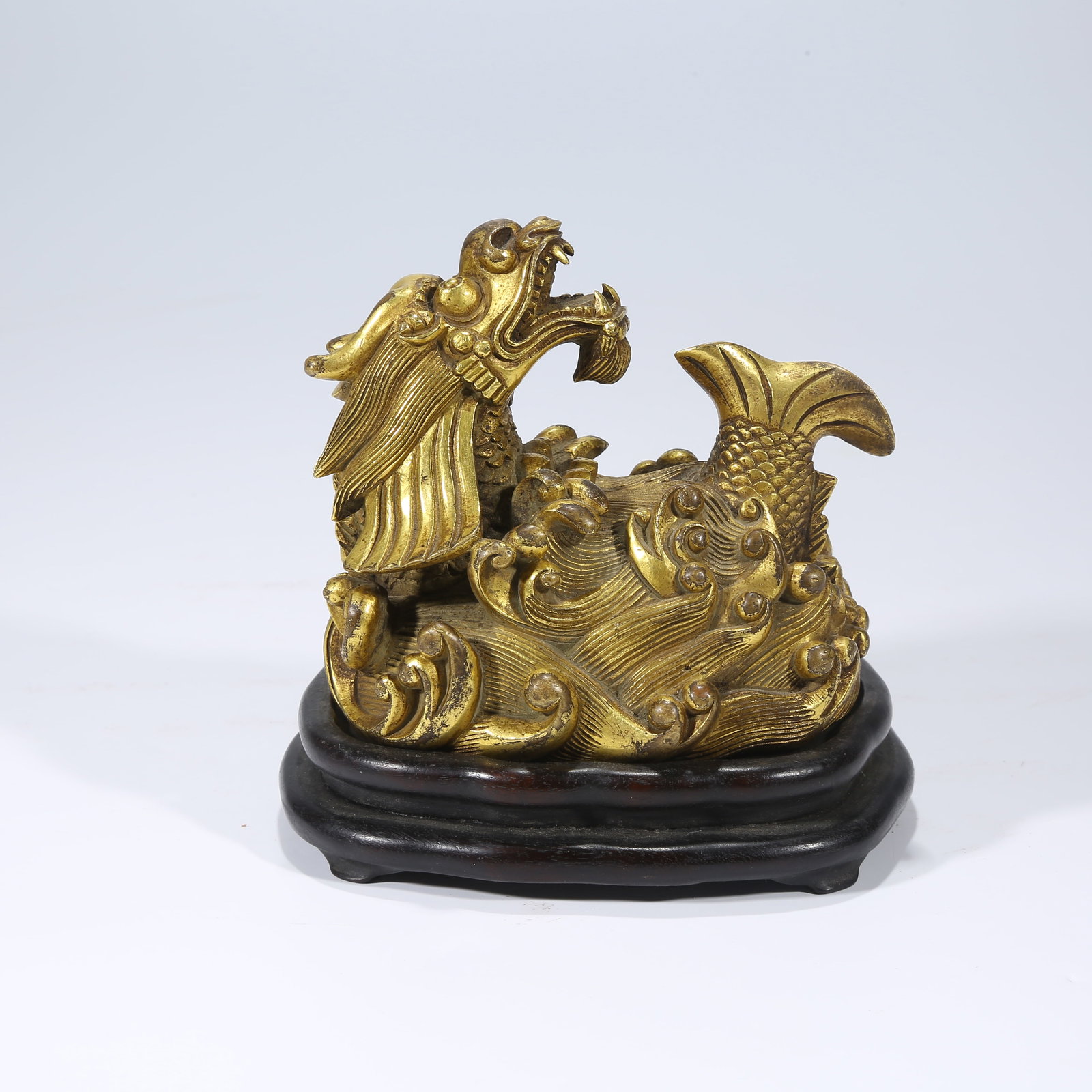 A GILT BRONZE FISH-TO-DRAGON TRANSFORMATION FIGURINE (1 of 8)