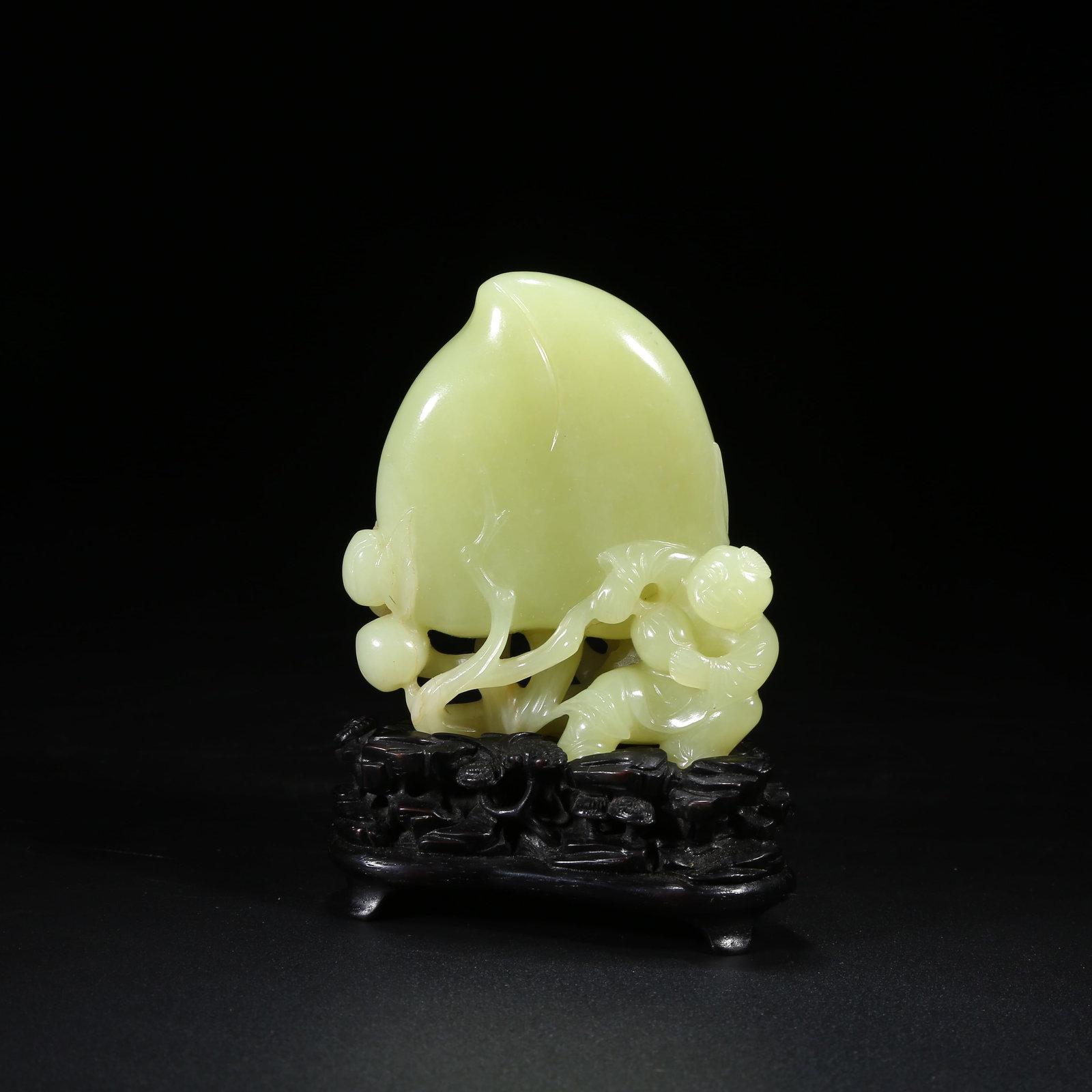 A YELLOW JADE FIGURINE OF CHILD OFFERING LONGEVITY: Yellow Jade Figurine of Child Offering Longevity
