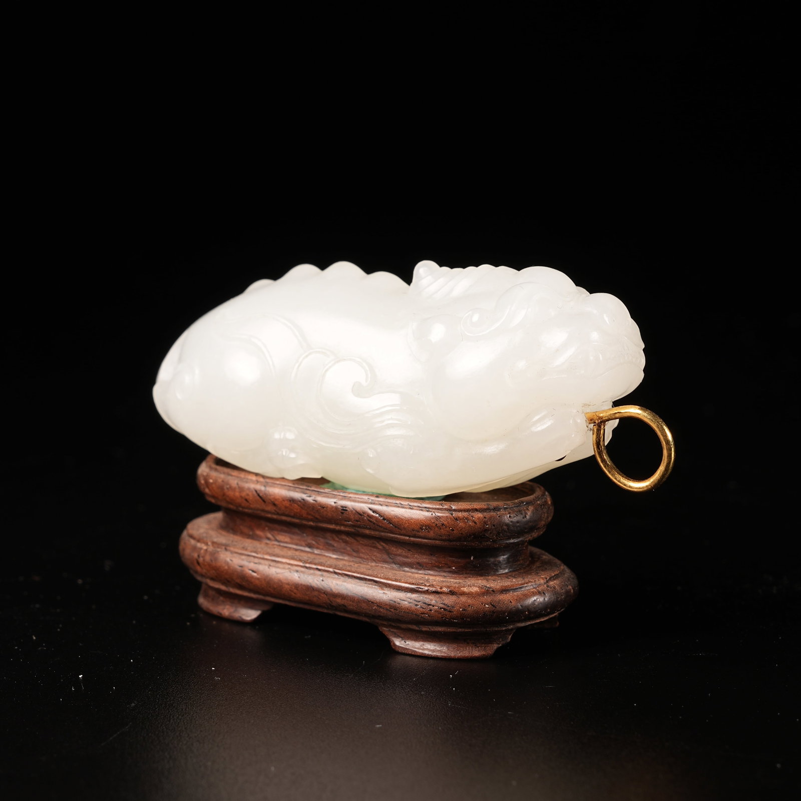 A HETIAN JADE AUSPICIOUS BEAST PENDANT (1 of 9)
