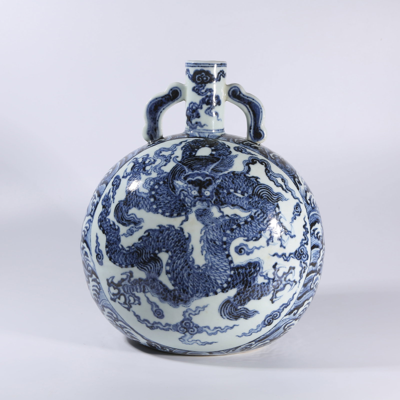 A BLUE-AND-WHITE MOON FLASK WITH DRAGON-AND-WAVES MOTIF AND RIBBON-SHAPED HANDLES (1 of 9)