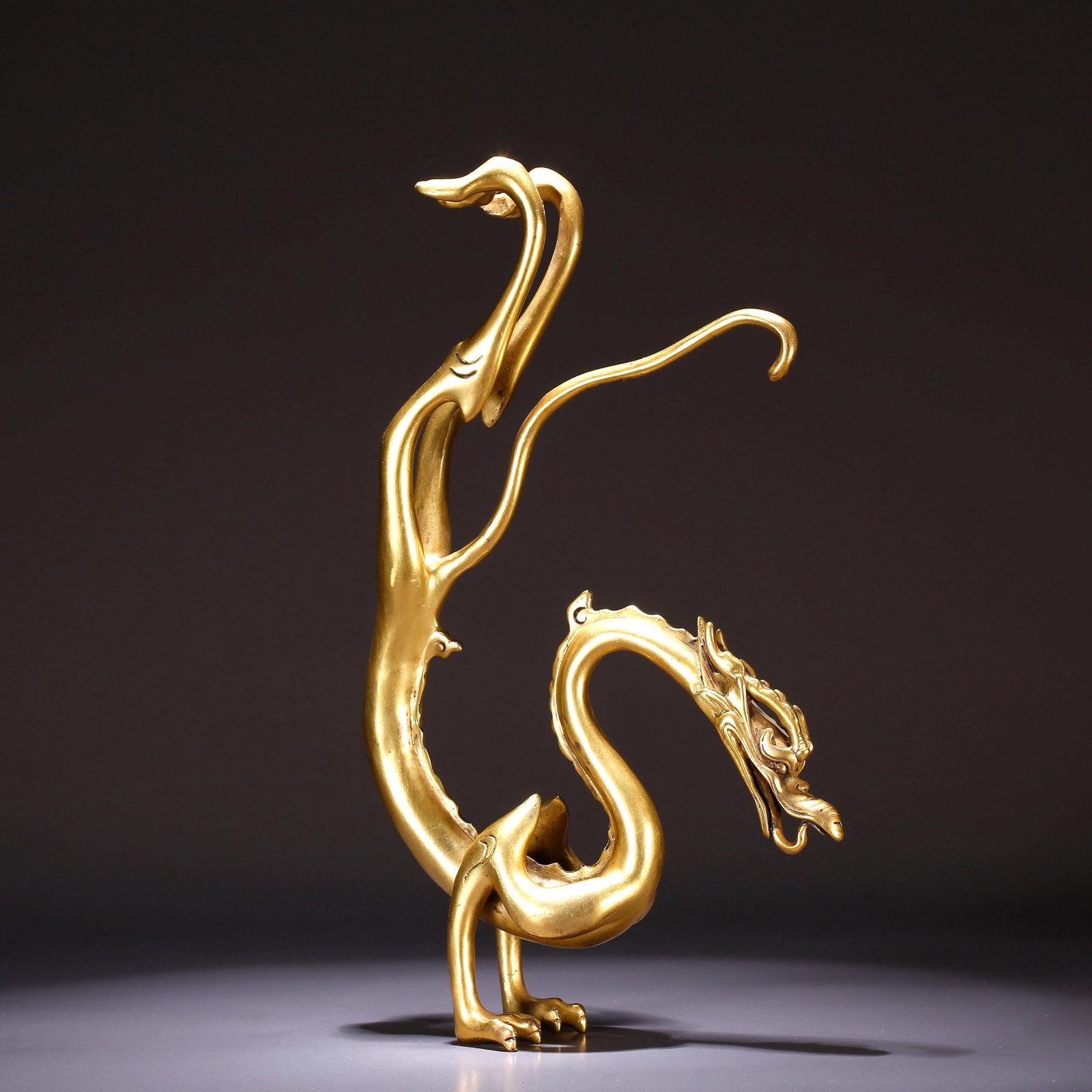 A GILT-BRONZE RECLINING DRAGON ORNAMENT (1 of 9)