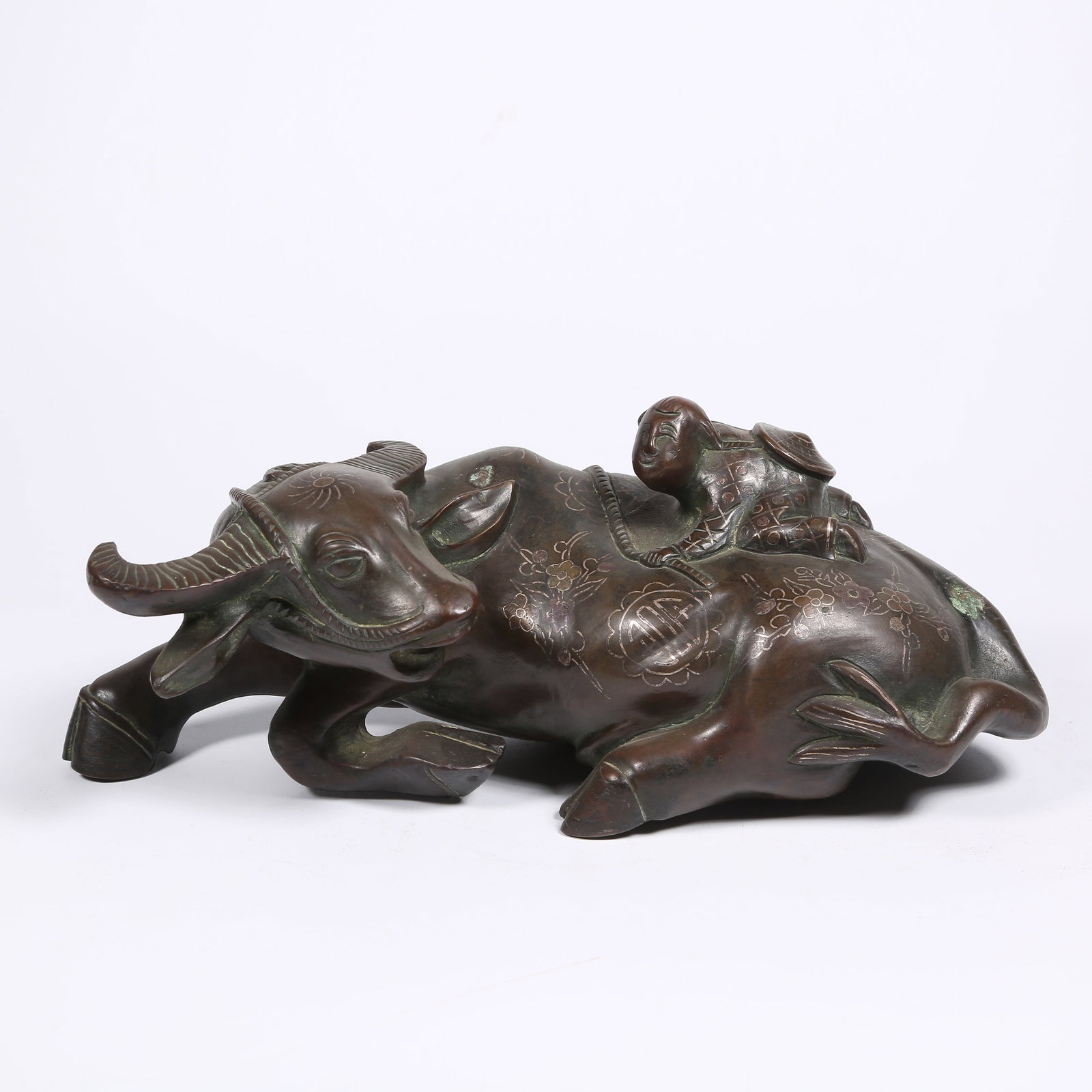 A BRONZE ORNAMENT OF BOY HERDING OX INLAID WITH SILVER: Bronze Ornament of Boy Herding Ox Inlaid with Silver