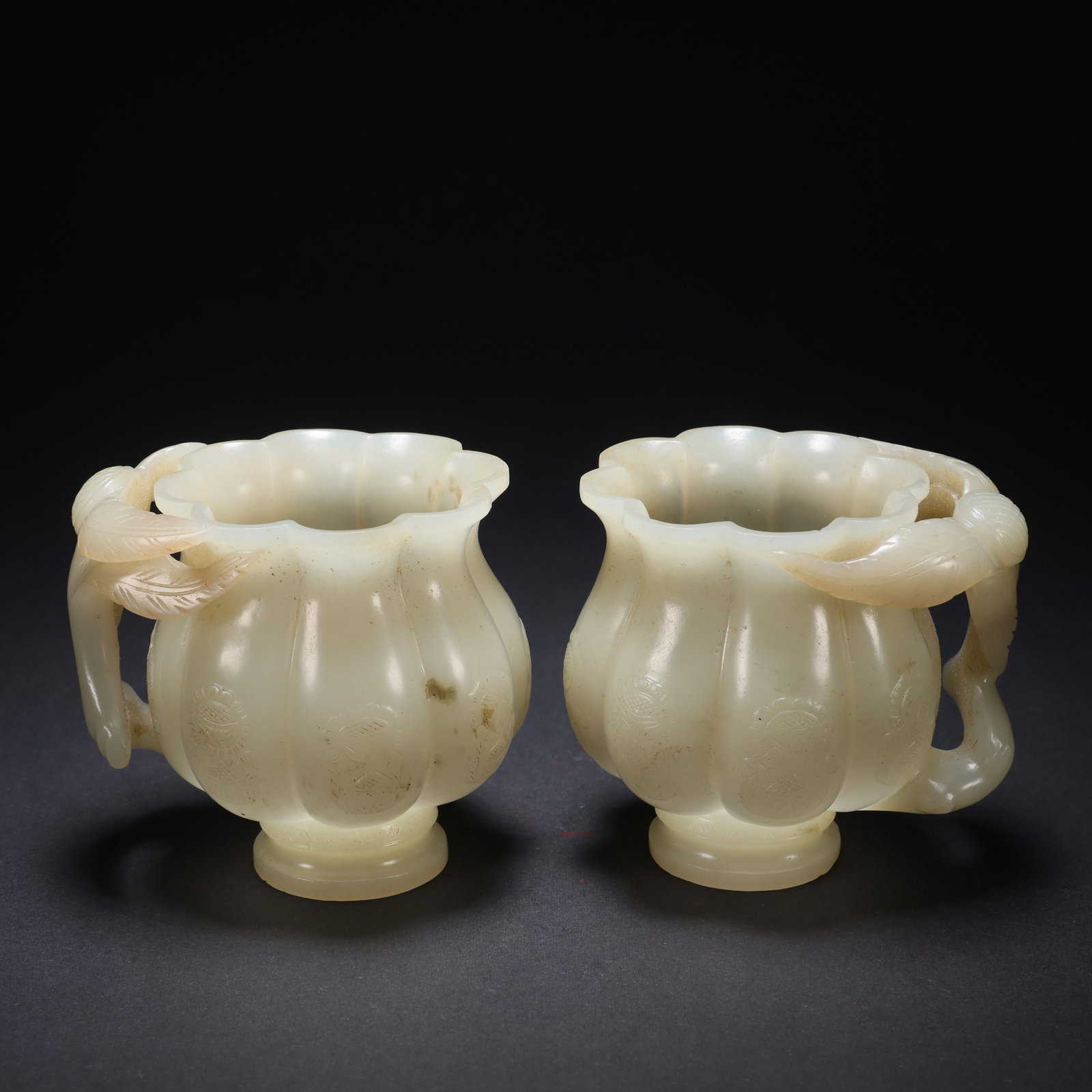 A HETIAN SEED JADE PEACH-BRANCH MELON-LOBED CUPS, PAIR (1 of 9)