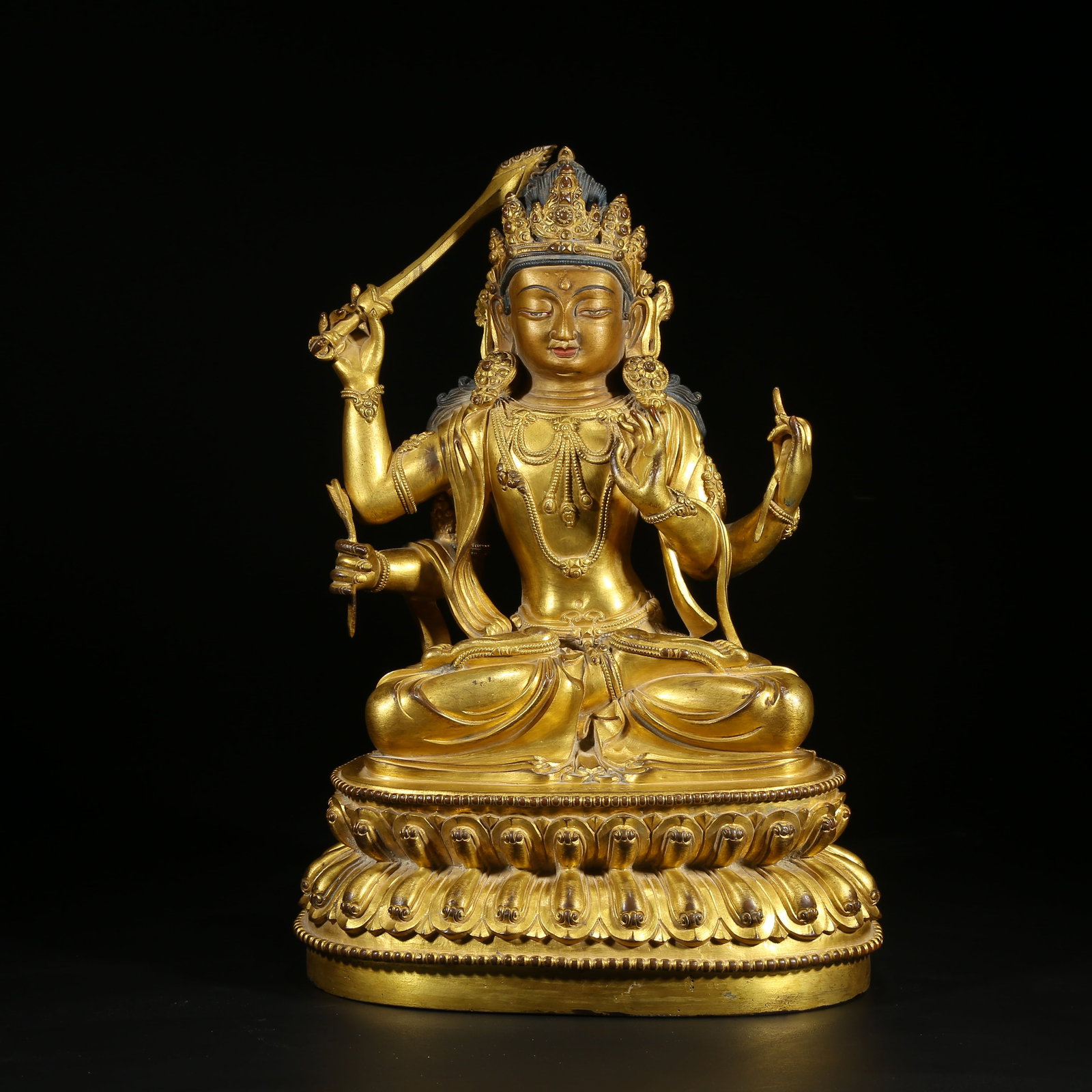 A GILT BRONZE FOUR-ARMED GUANYIN STATUE: Gilt Bronze Four-Armed Guanyin Statue