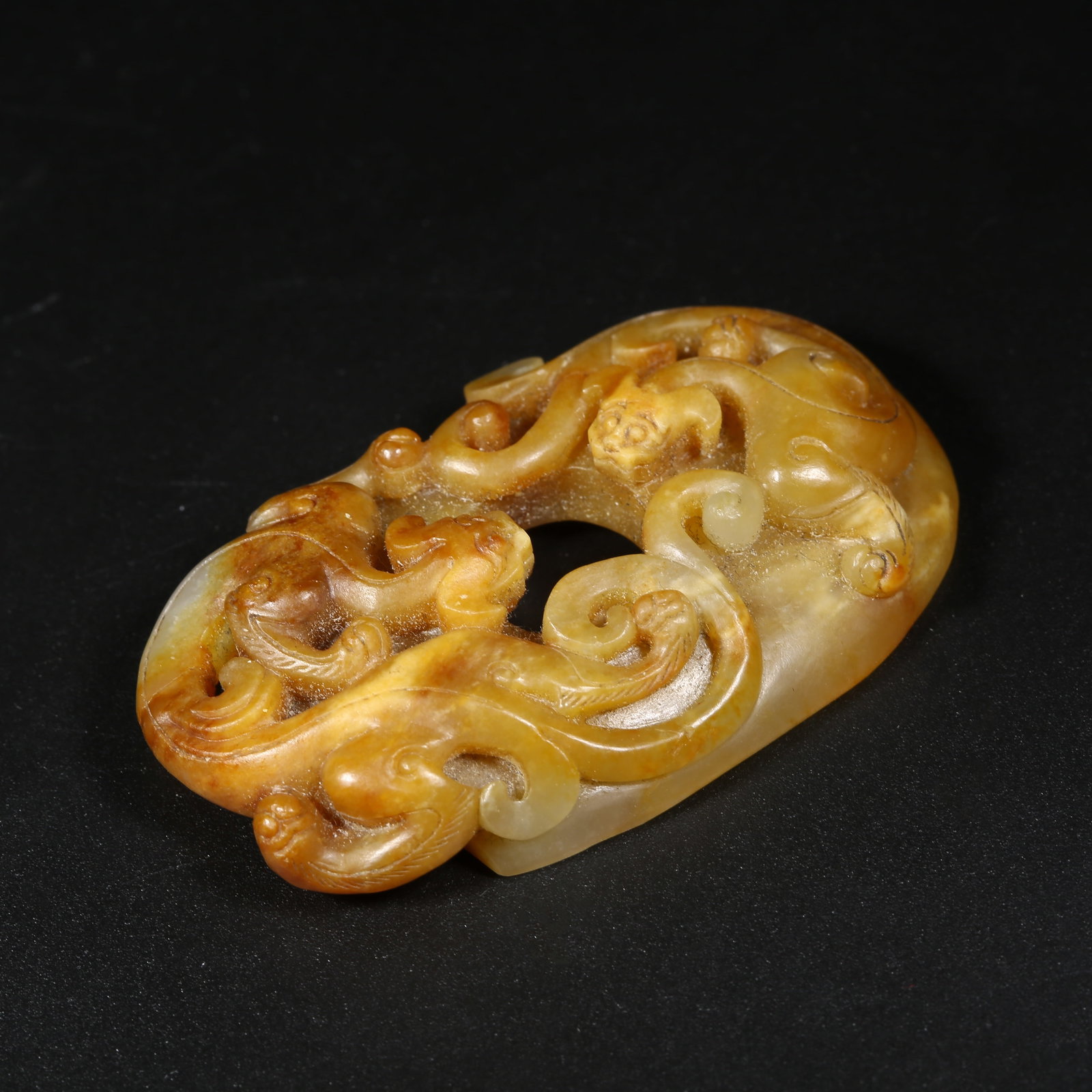 A ANCIENT JADE CHICKEN-HEART PENDANT WITH CHI-DRAGON MOTIF (1 of 7)