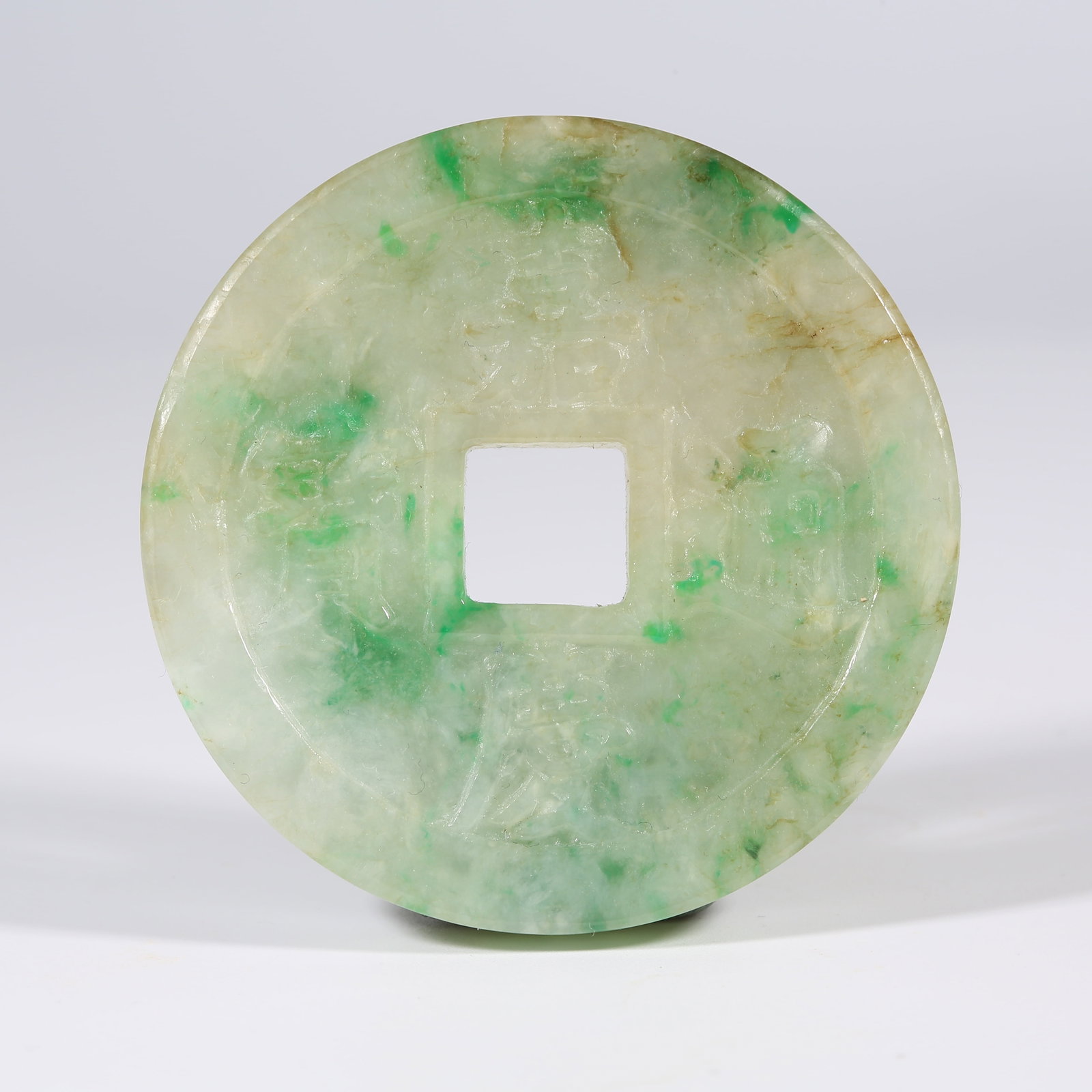 A JADEITE FLOWER COIN: Jadeite Flower Coin