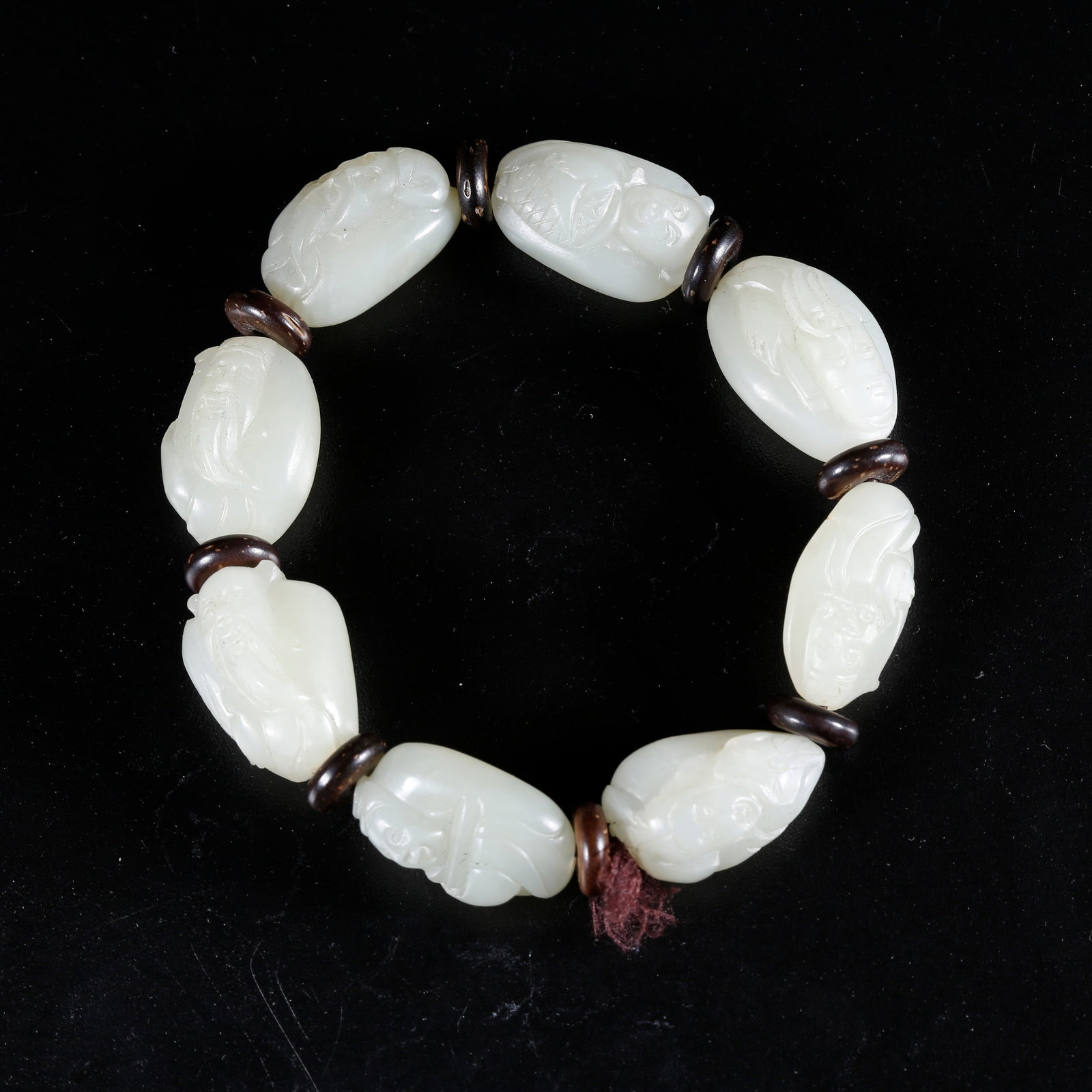 A HETIAN JADE CARVED BEADED BRACELET (1 of 9)
