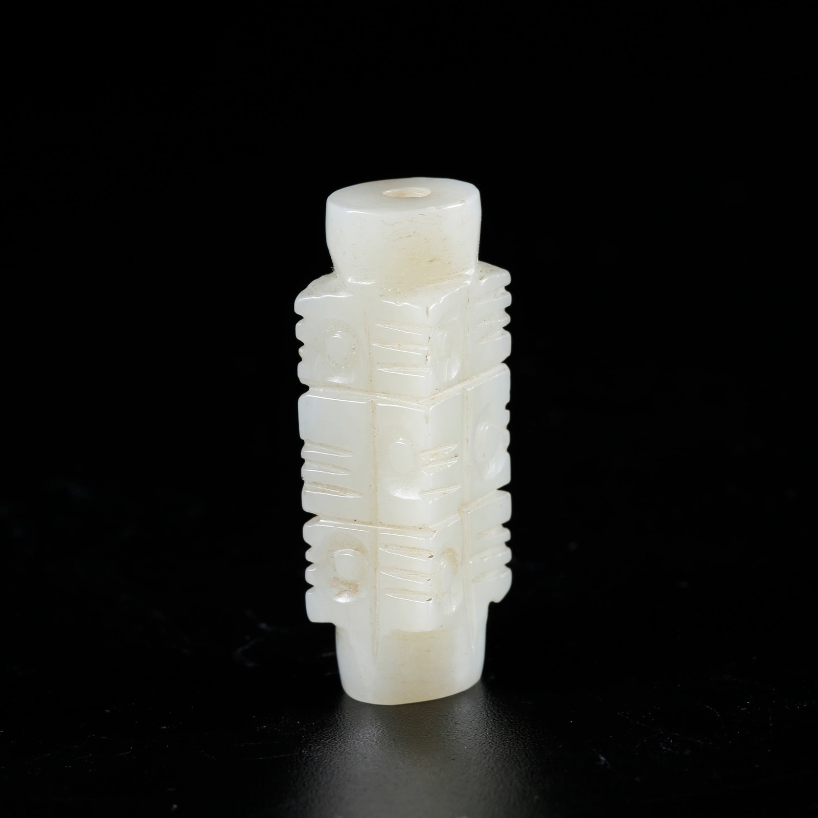 A HETIAN JADE CARVED CONG-SHAPED CYLINDRICAL BEAD: Hetian jade carved cong-shaped cylindrical bead