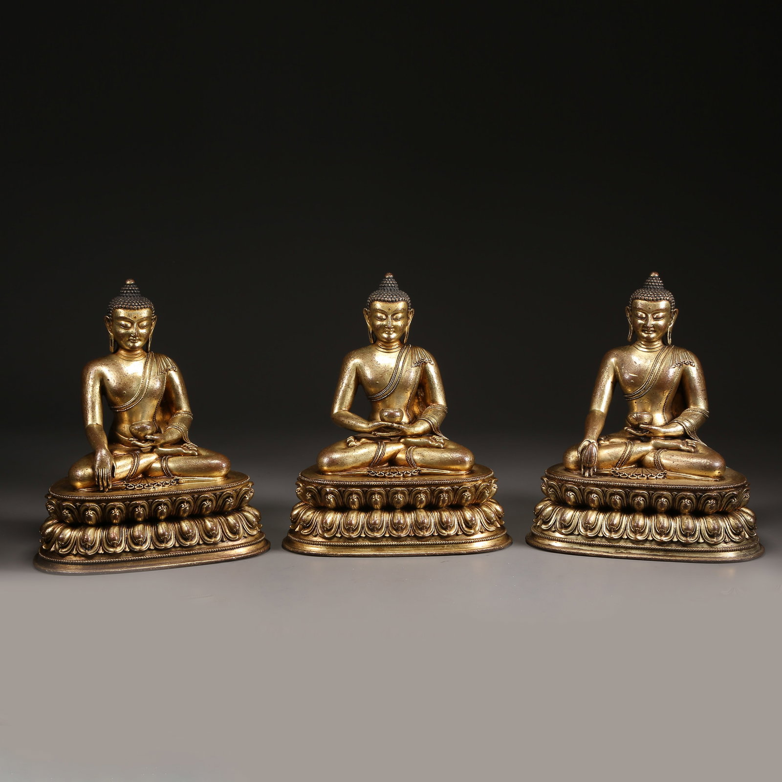 A SET OF GILT BRONZE BUDDHAS OF THE THREE AGES (1 of 13)