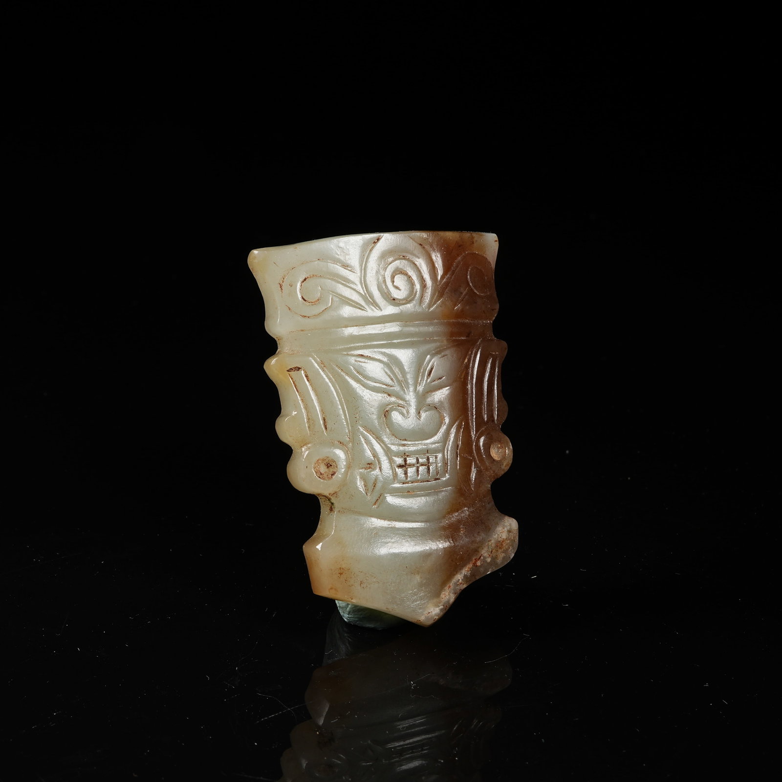 A ARCHAIC JADE ANTHROPOMORPHIC FACE PENDANT (1 of 9)
