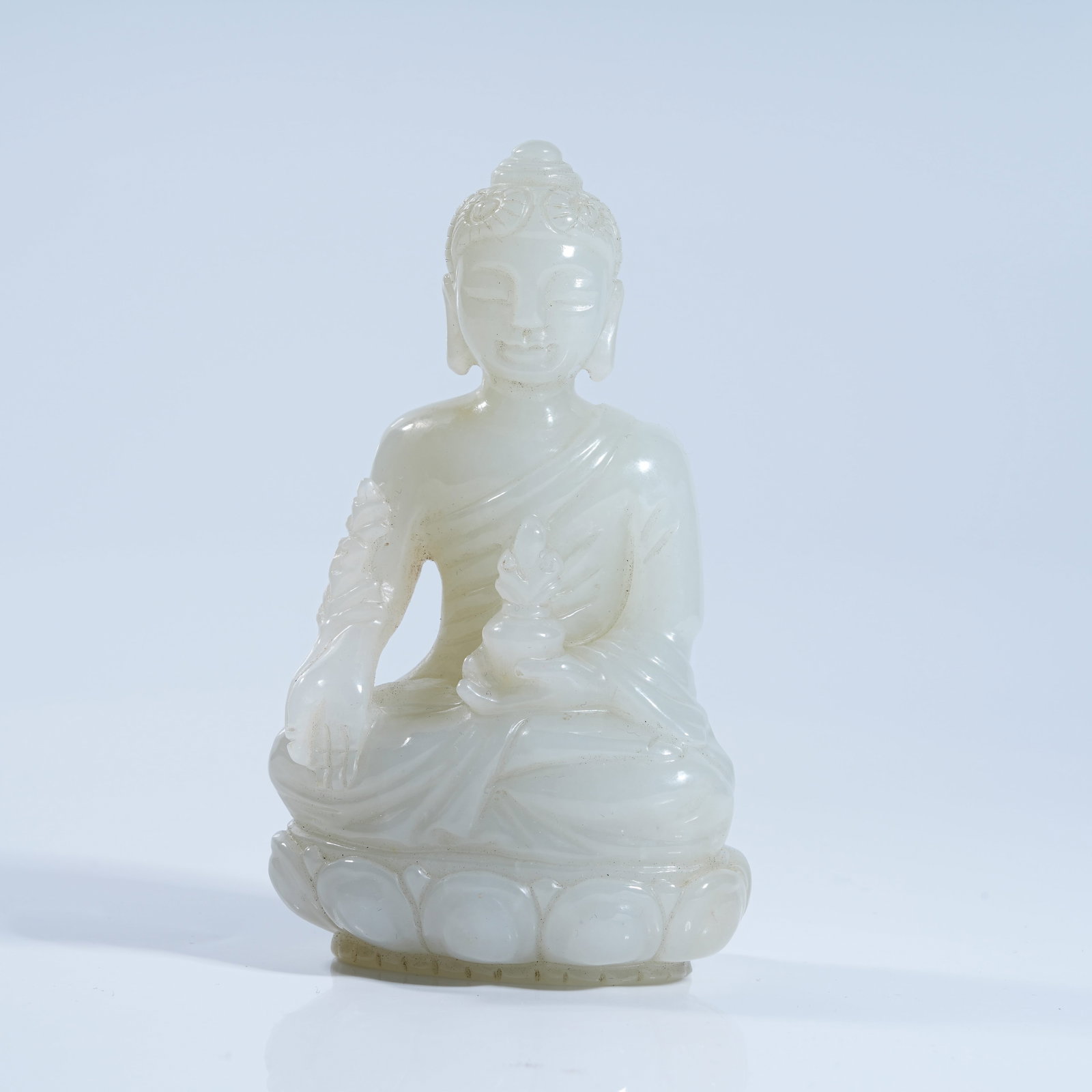 A HETIAN WHITE JADE STATUE OF MEDICINE BUDDHA (1 of 9)