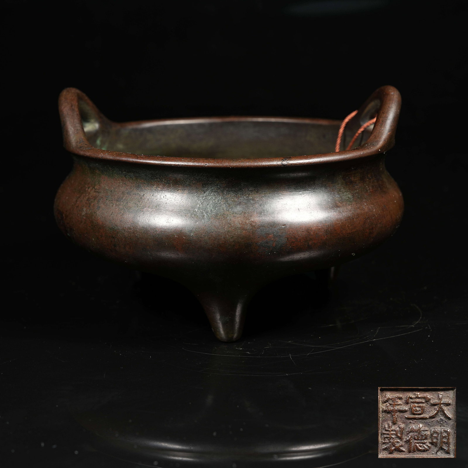 A COPPER THREE-LEGGED BRIDGE-EAR CENSER (1 of 9)