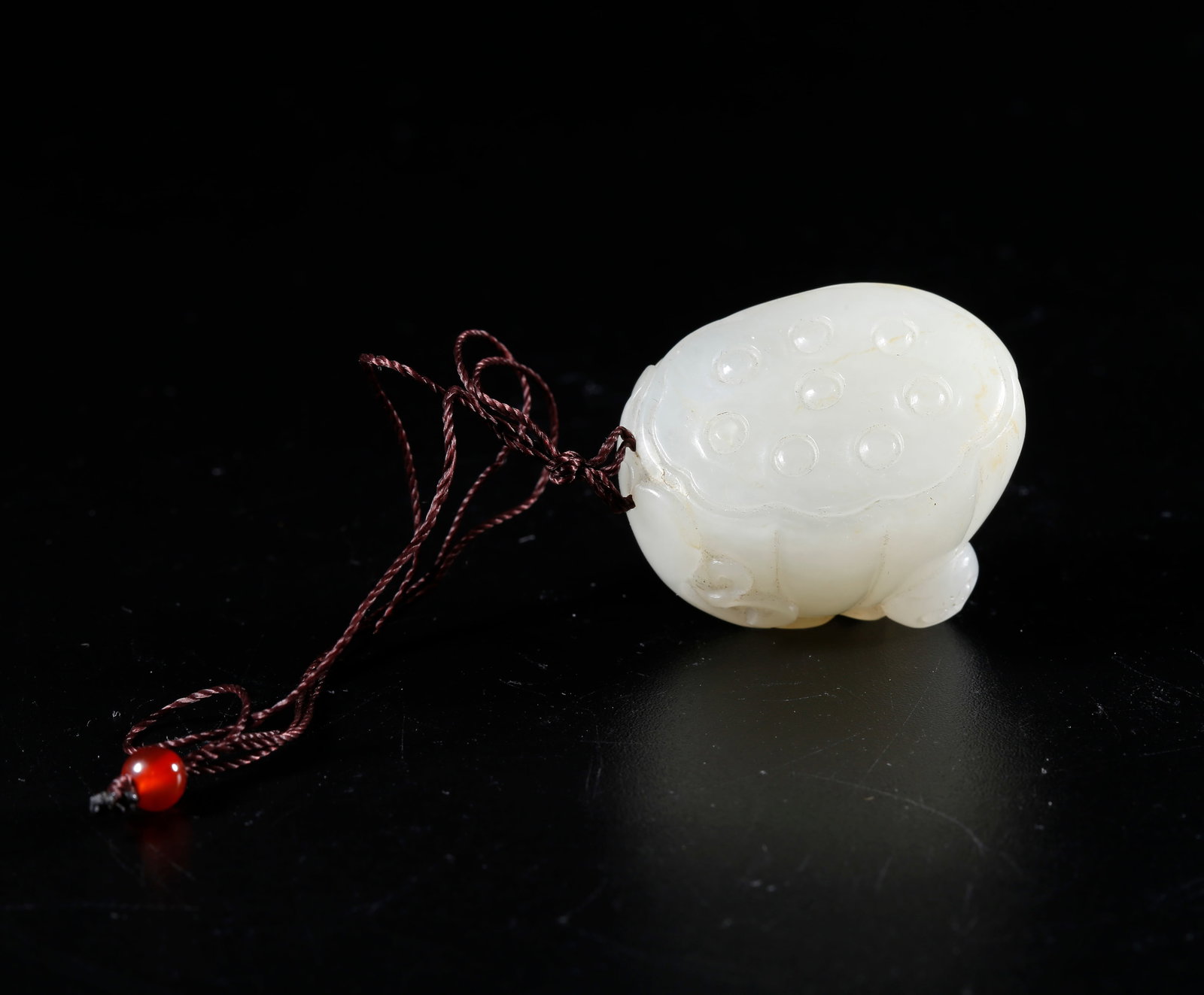 A HETIAN JADE CARVED LOTUS-SEED-SHAPED PENDANT (1 of 9)