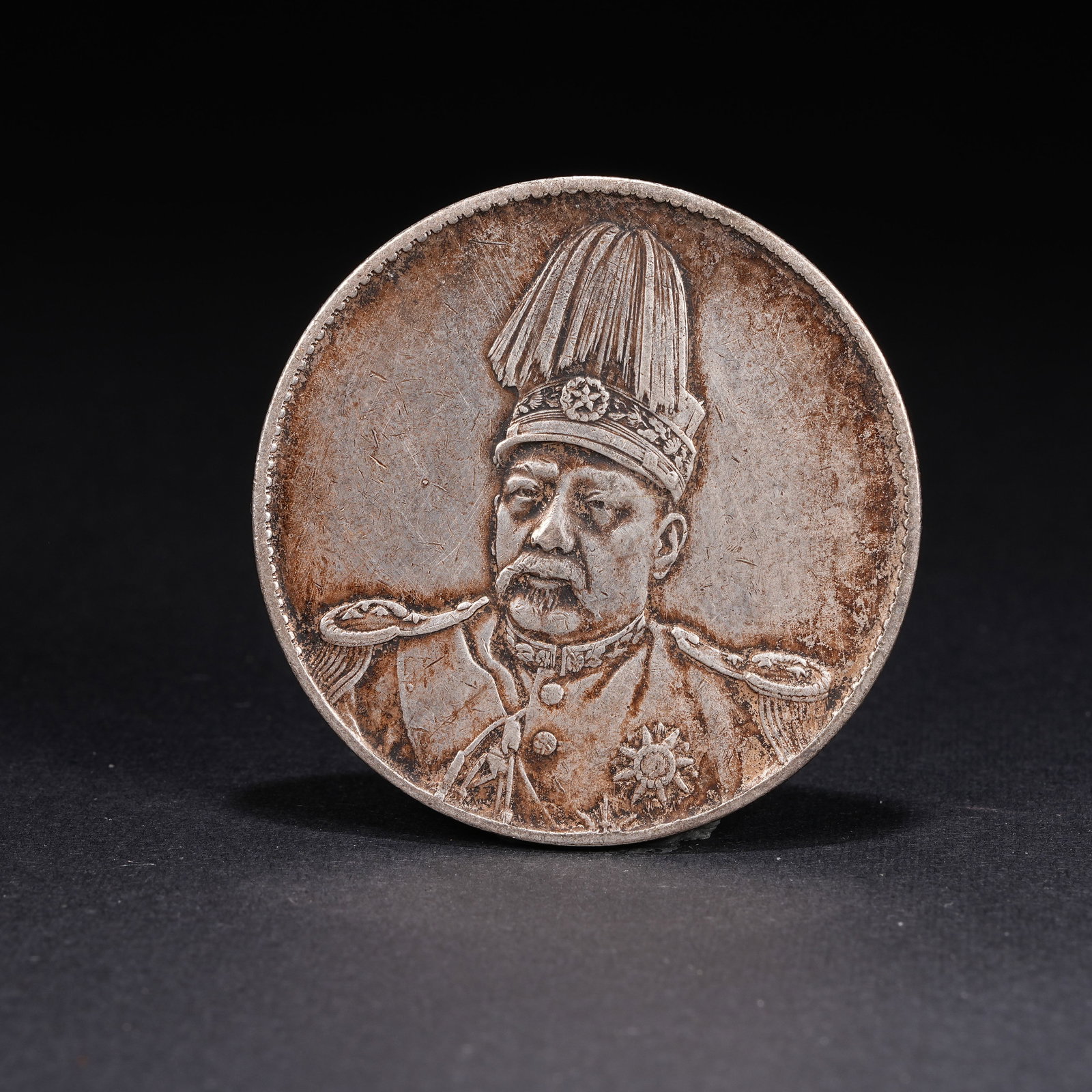 A SILVER DOLLAR COIN: One Silver dollar Coin