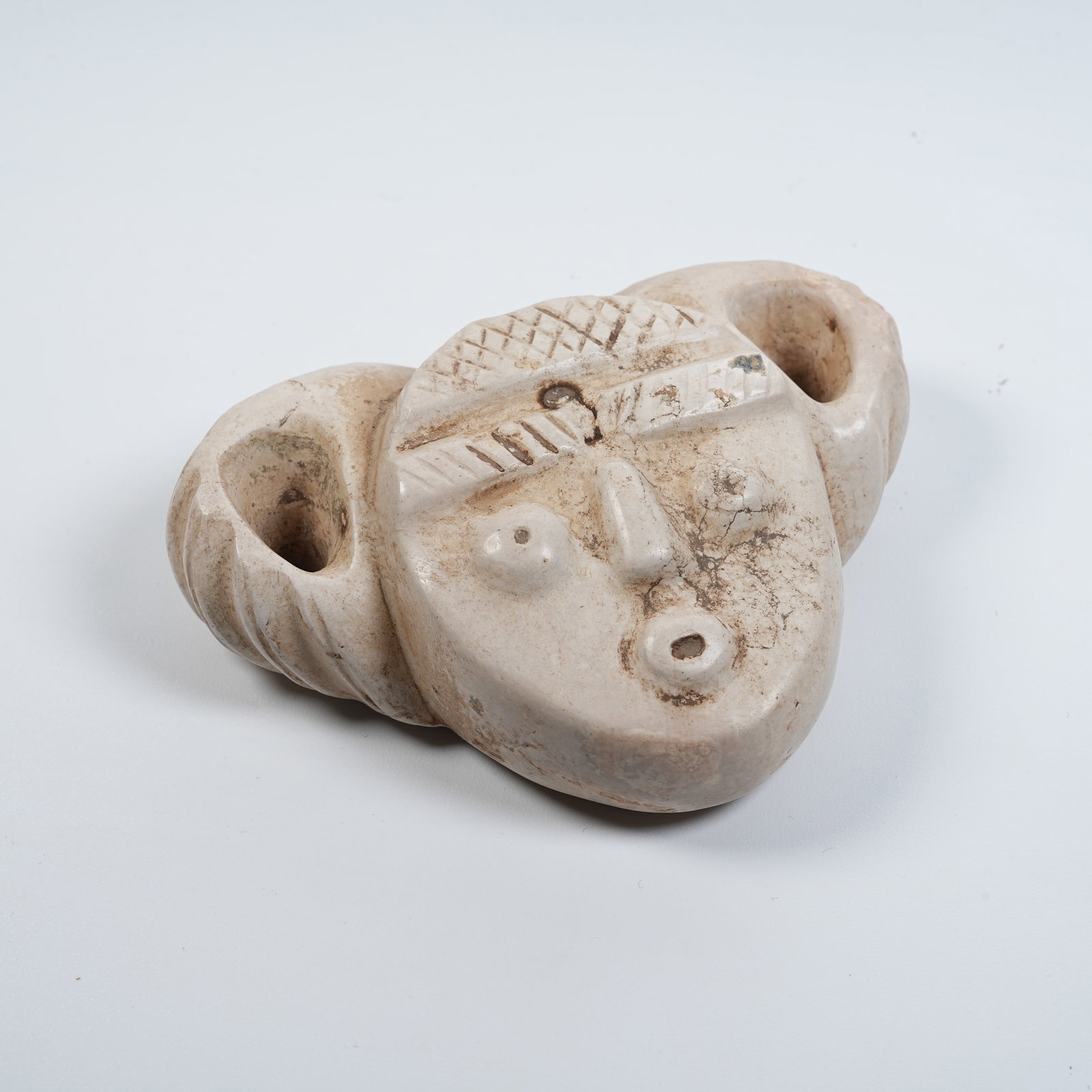 A ARCHAIC JADE ANTHROPOMORPHIC FACE PENDANT (1 of 8)