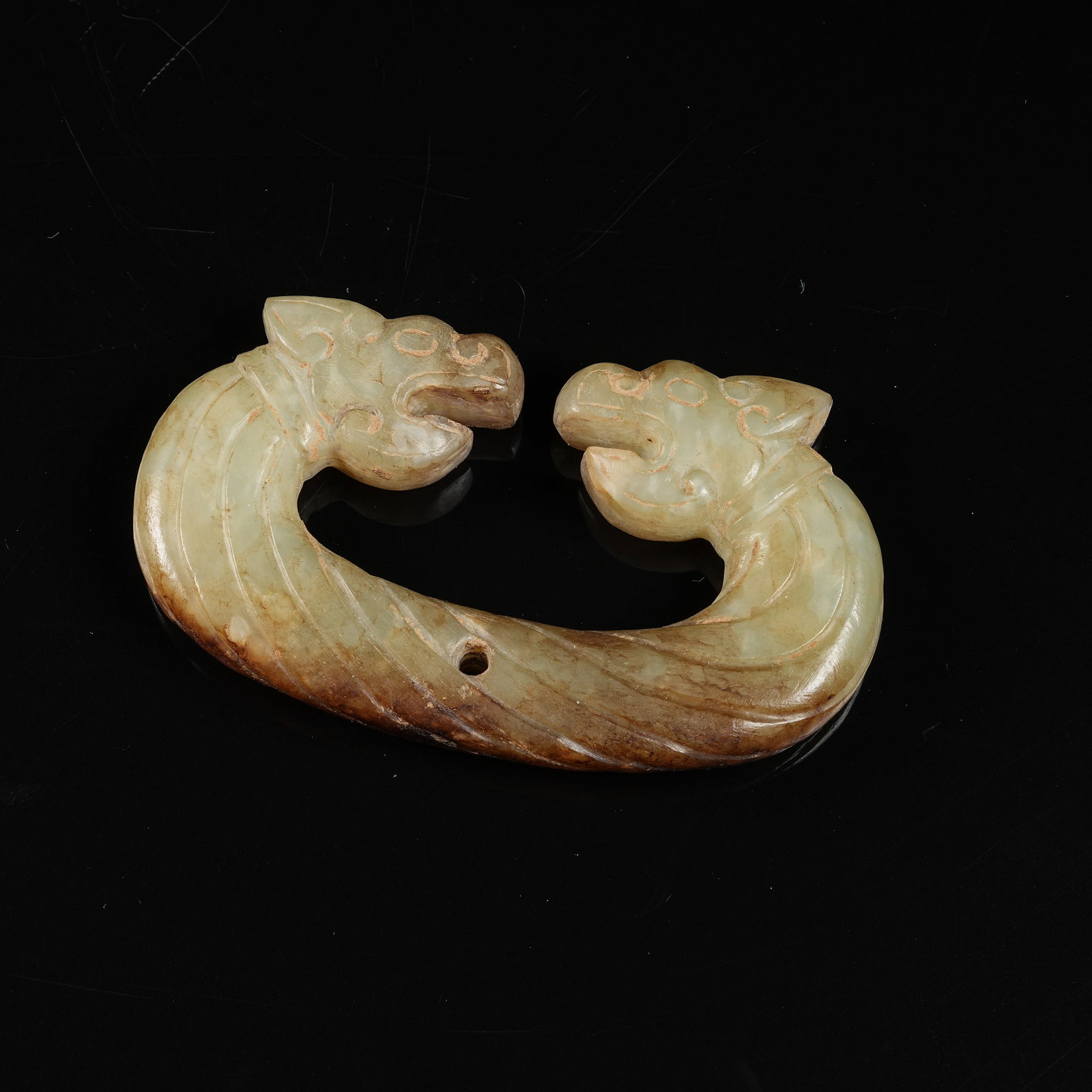 A ARCHAIC JADE DOUBLE-DRAGON CLASP: Archaic jade double-dragon clasp