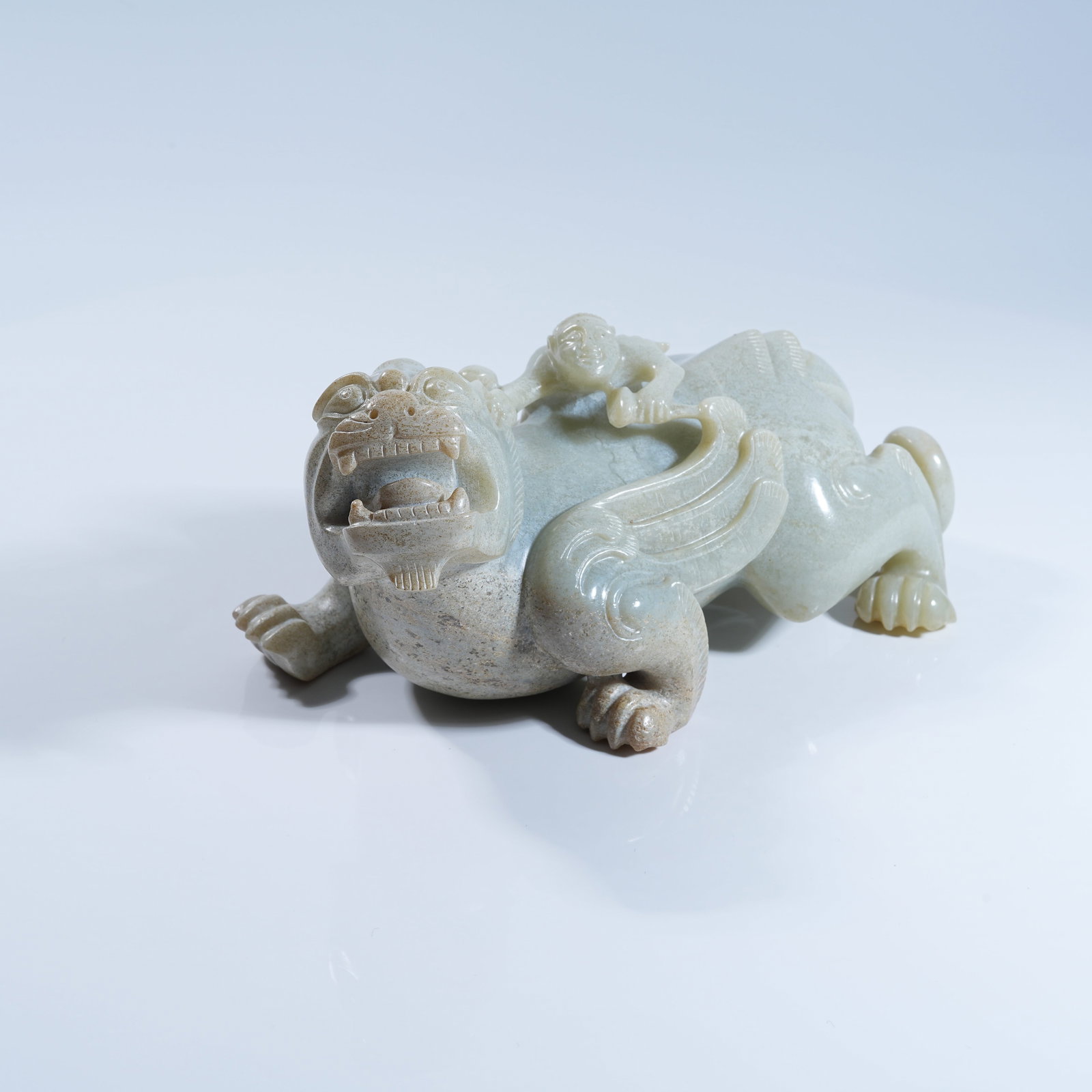 A ANCIENT JADE ORNAMENT OF FEATHERED FIGURE RIDING BEAST (1 of 8)
