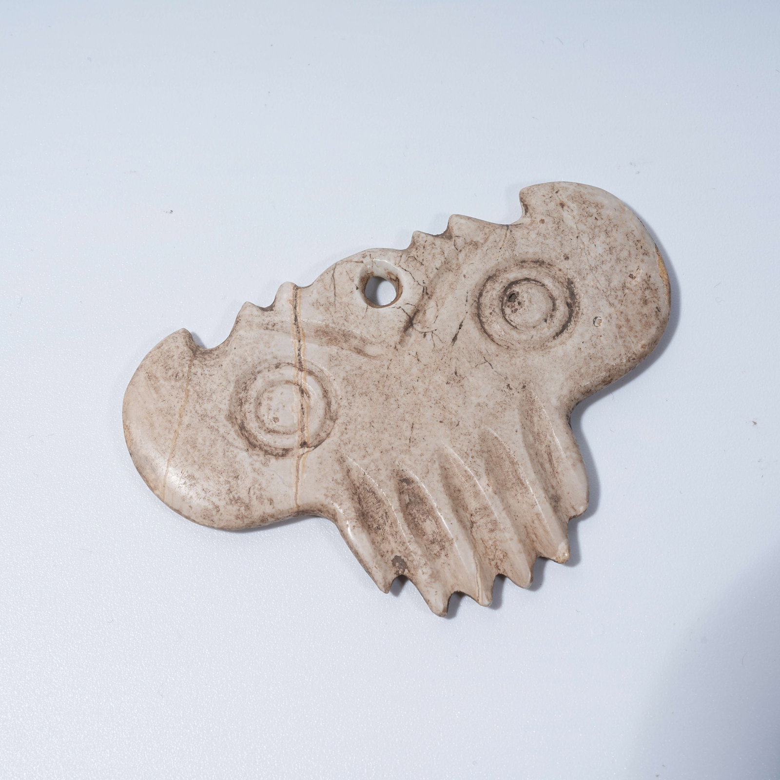A HONGSHAN CULTURE ARCHAIC JADE CLOUD-SCROLL PENDANT: Hongshan Culture archaic jade cloud-scroll pendant