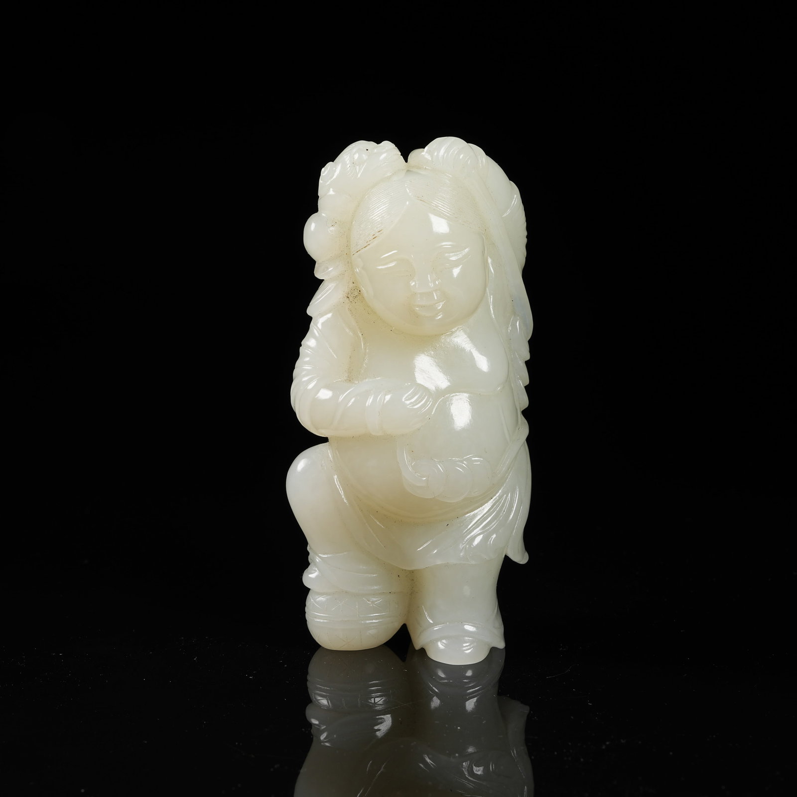 A HETIAN WHITE JADE LIU HAI PLAYING WITH THE THREE-LEGGED TOAD FIGURINE: Hetian white jade Liu Hai playing with the three-legged toad figurine