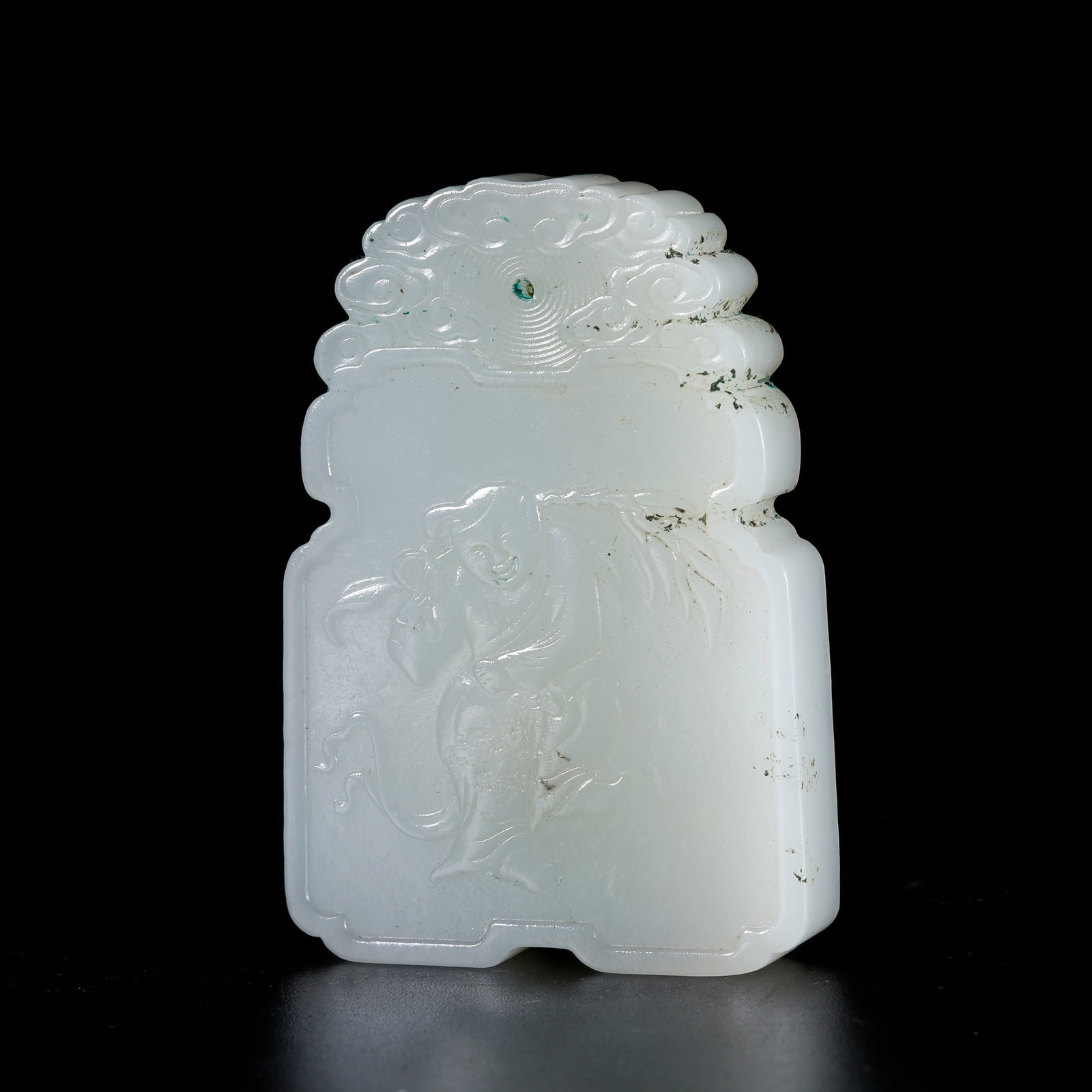 A HETIAN JADE CARVED BOY MOTIF PENDANT: Hetian jade carved boy motif pendant