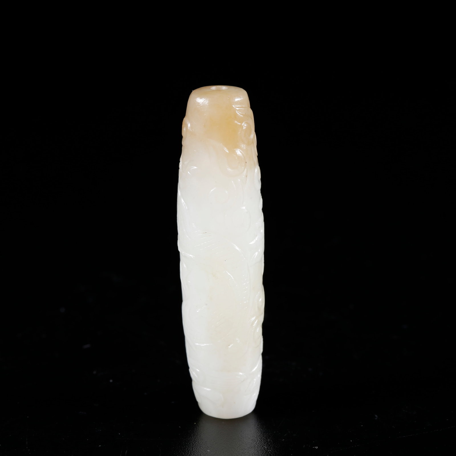 A HETIAN JADE CARVED DRAGON-PATTERN CYLINDRICAL BEAD: Hetian jade carved dragon-pattern cylindrical bead