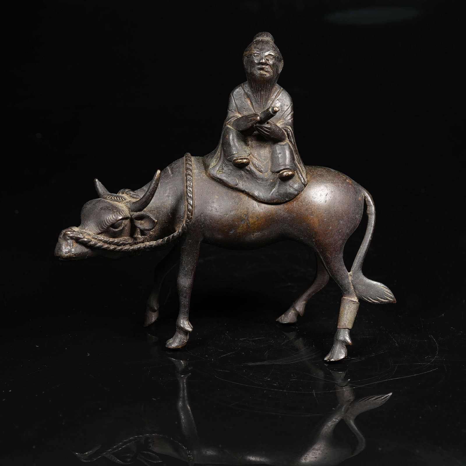 A COPPER ORNAMENT OF LAOZI RIDING AN OX: Copper Ornament of Laozi Riding an Ox