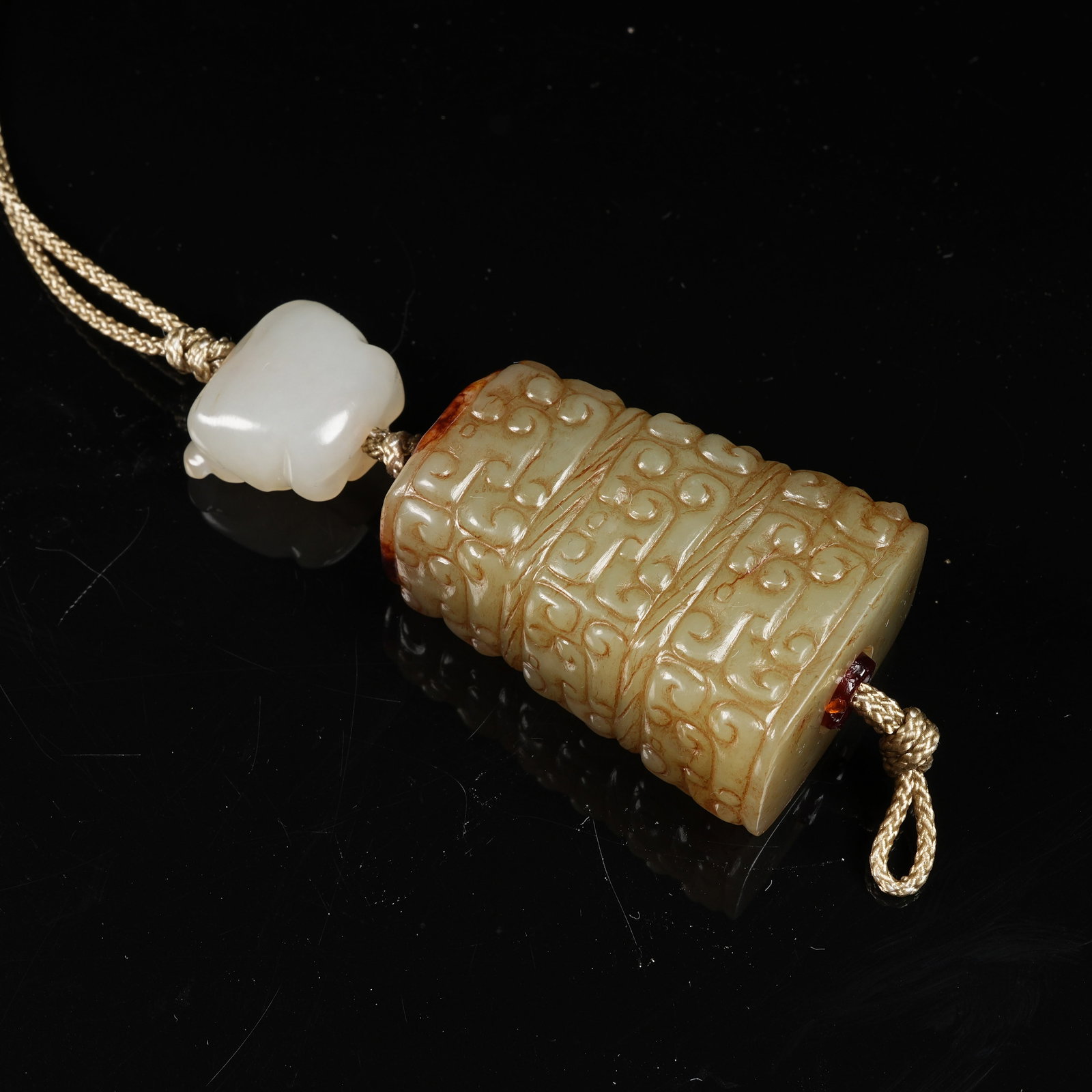 A ARCHAIC JADE CLOUD-SCROLL PATTERN CYLINDRICAL BEAD - 10
