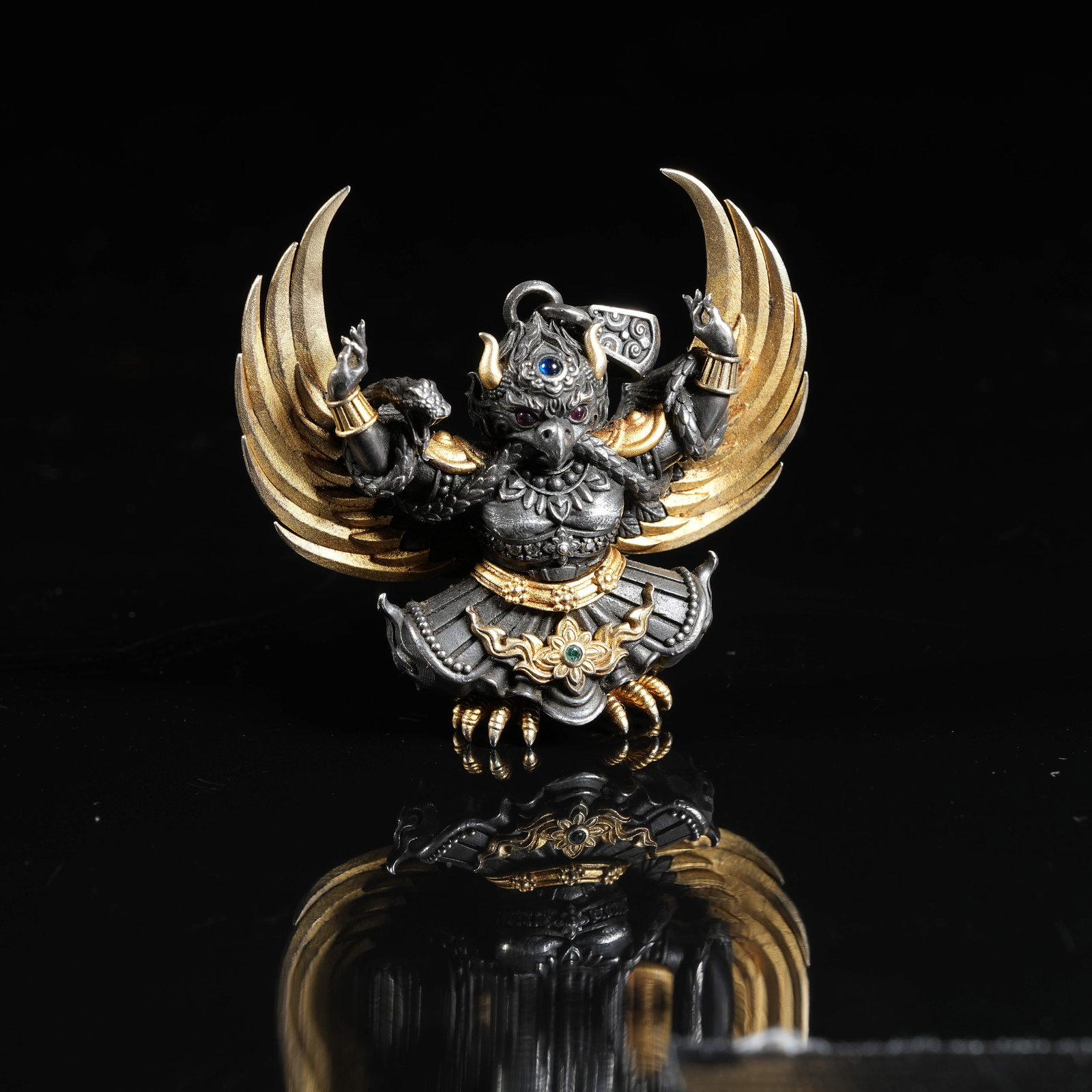 A GILT SILVER GEM-EMBEDDED GARUDA PENDANT: Gilt Silver Gem-embedded Garuda Pendant
