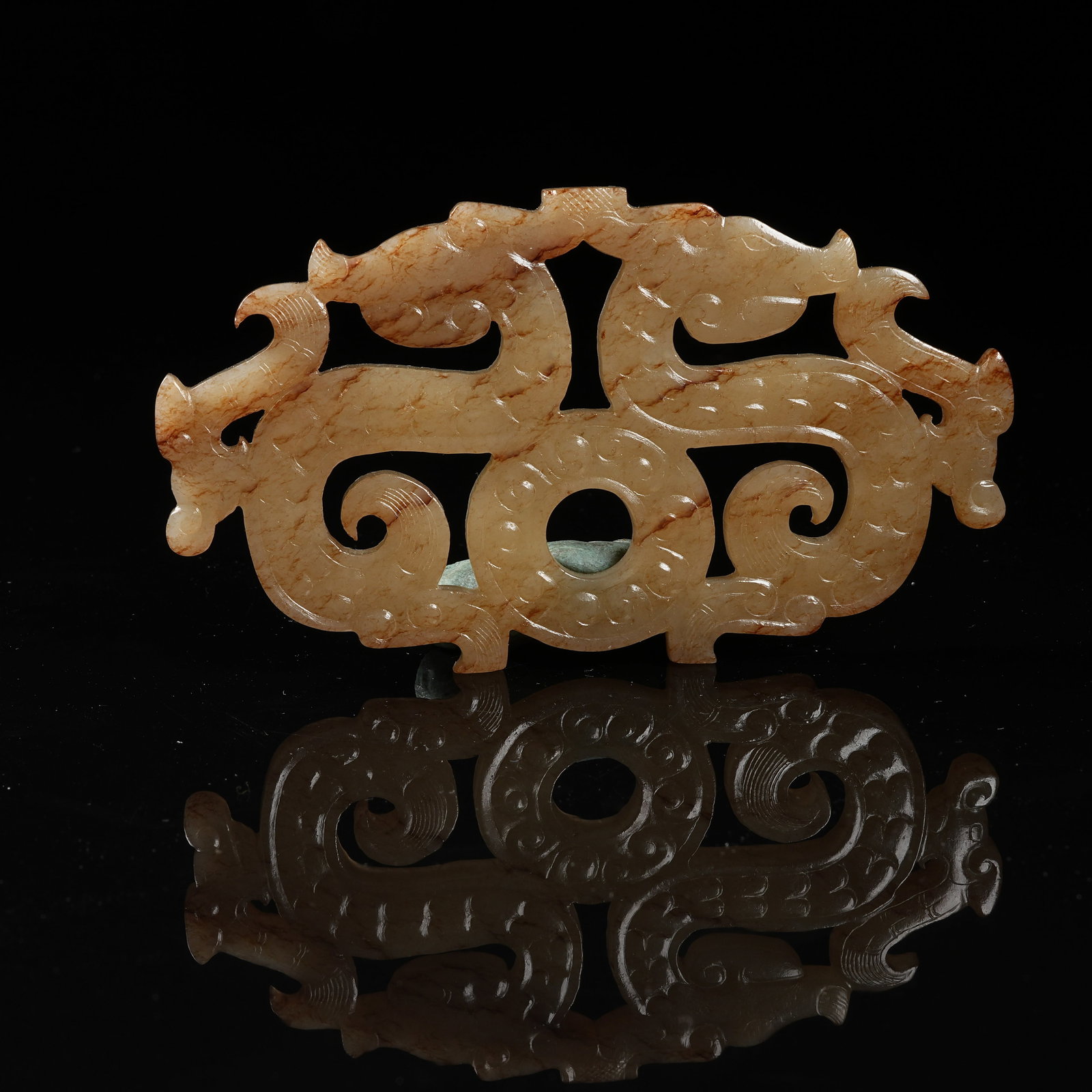 A ARCHAIC JADE DOUBLE-DRAGON PENDANT: Archaic jade double-dragon pendant