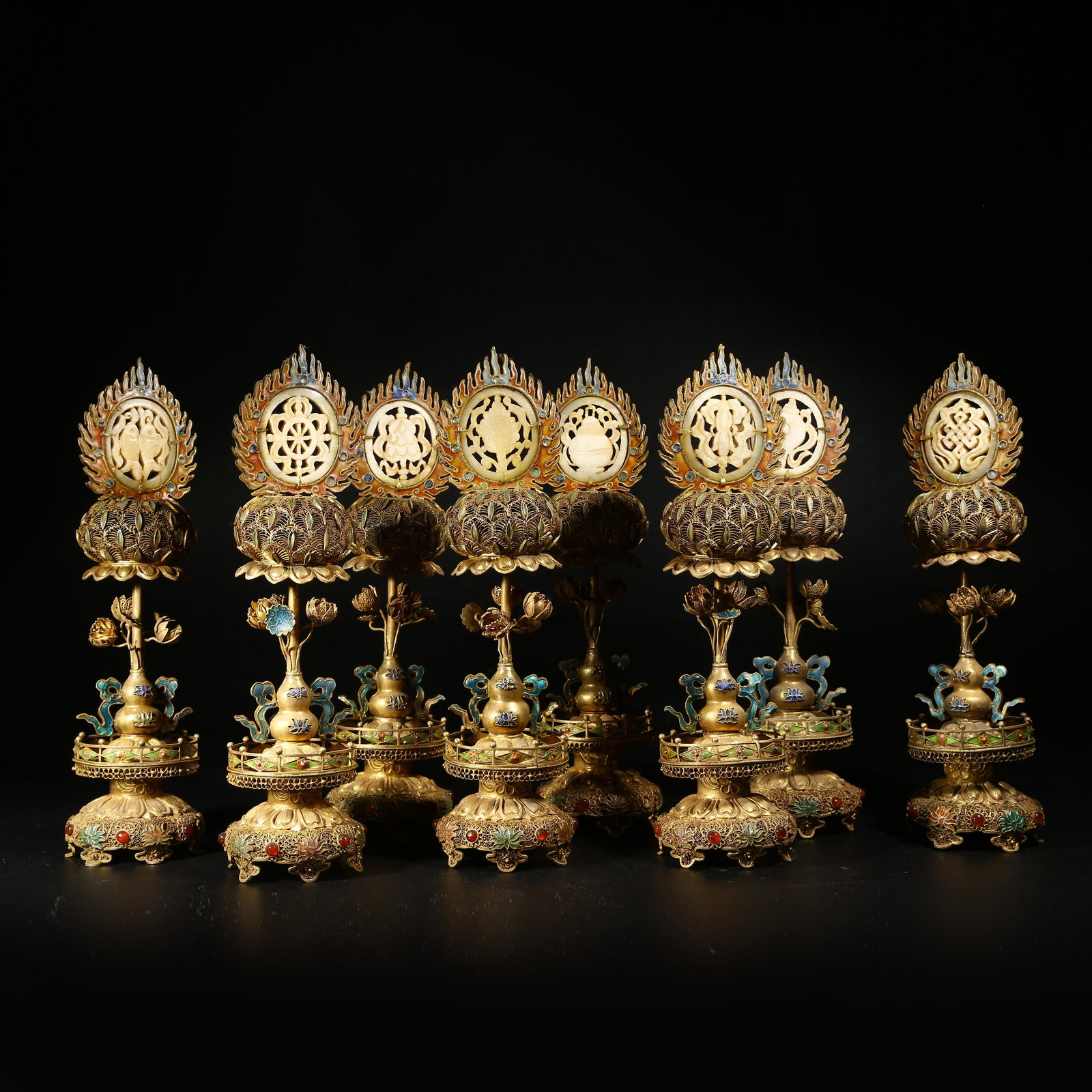 A GILDED SILVER FILIGREE RITUAL OFFERING SET WITH EIGHT AUSPICIOUS SYMBOLS INLAID WITH HETIAN JADE: Gilded silver filigree ritual offering set with Eight Auspicious Symbols inlaid with Hetian jade