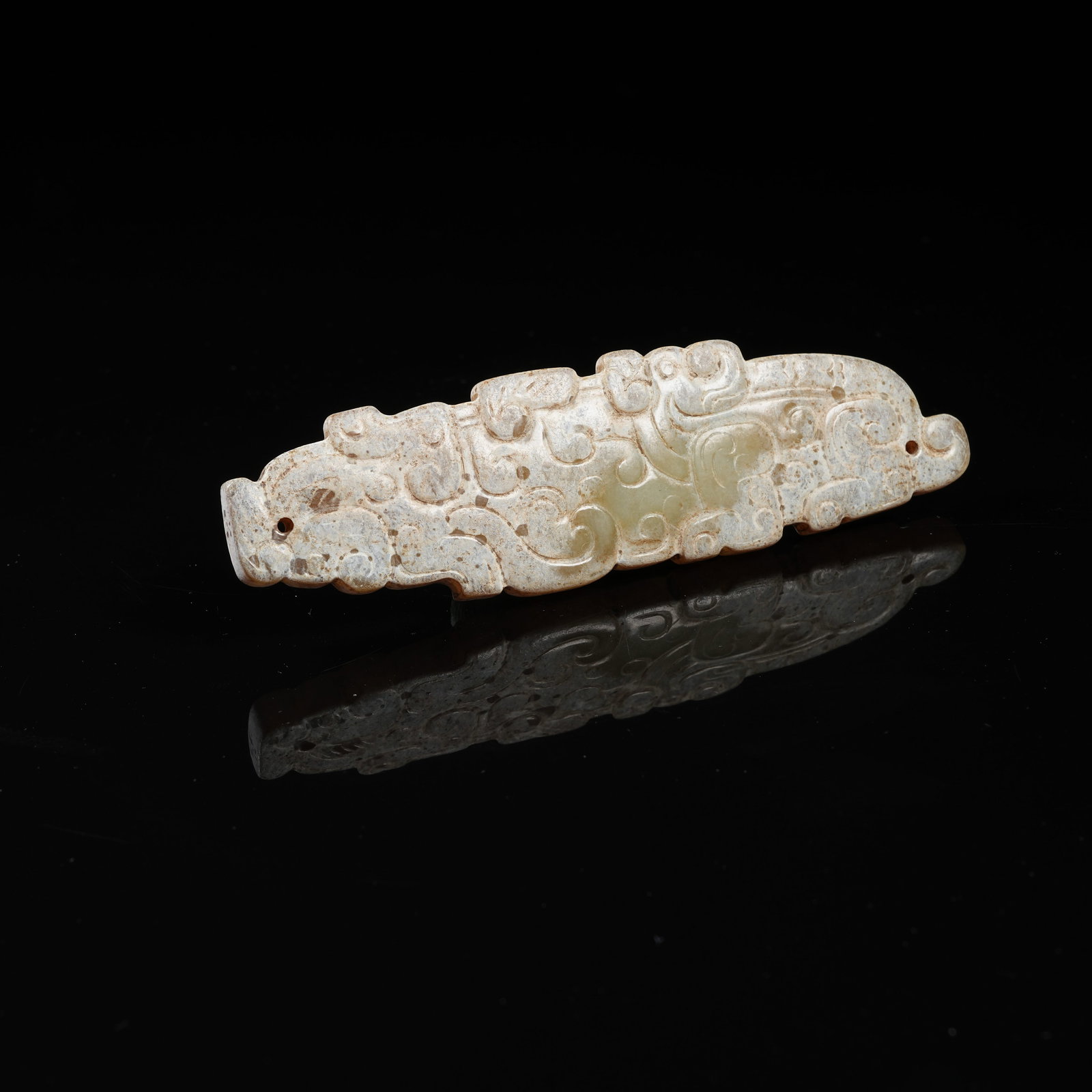 A ARCHAIC JADE CLOUD-SCROLL PATTERN PENDANT: Archaic jade cloud-scroll pattern pendant