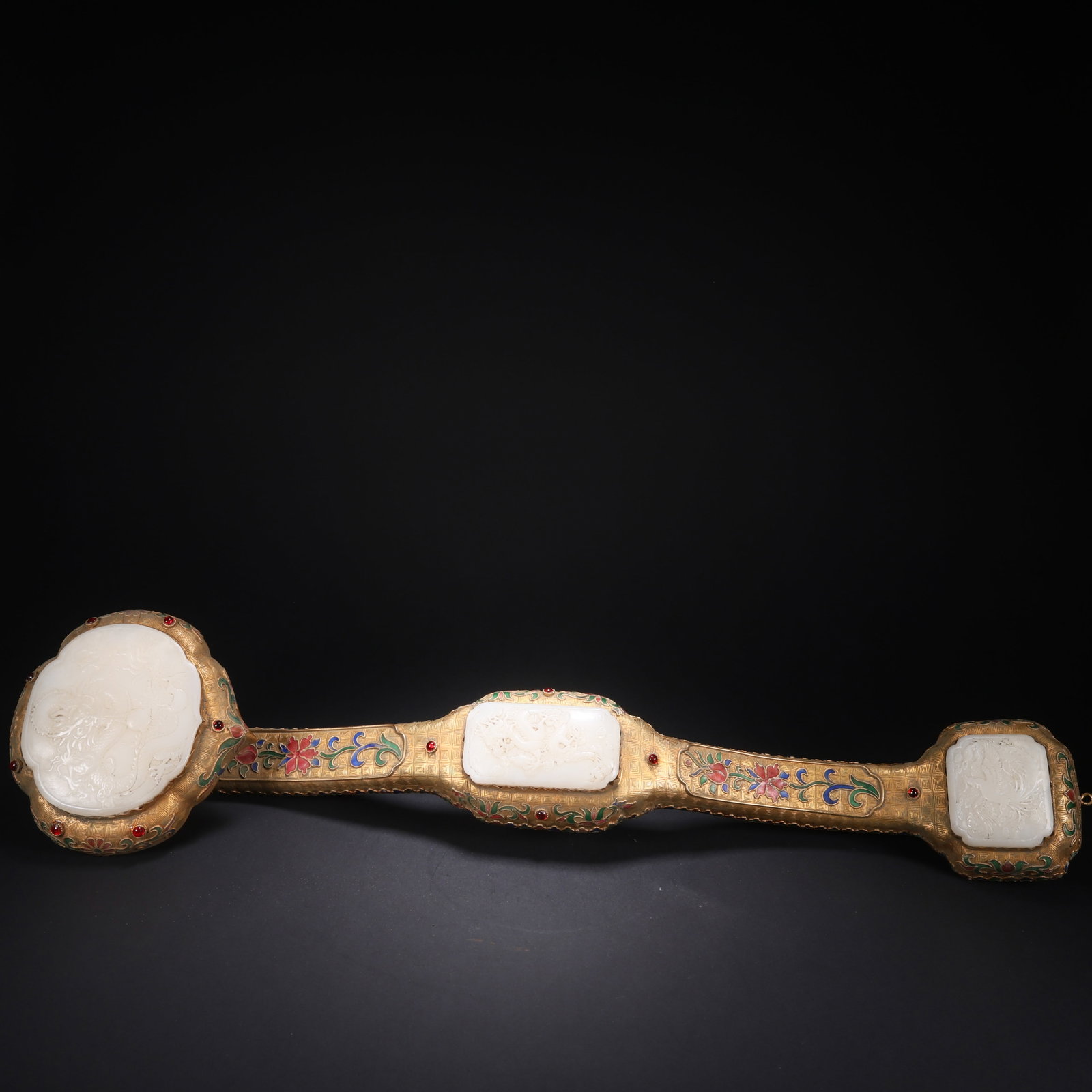 A HETIAN JADE GILT-BRONZE CLOISONNÉ GEM-INLAID "TWO DRAGONS, ONE PHOENIX" RUYI: Hetian Jade Gilt-Bronze Cloisonné Gem-Inlaid "Two Dragons, One Phoenix" Ruyi