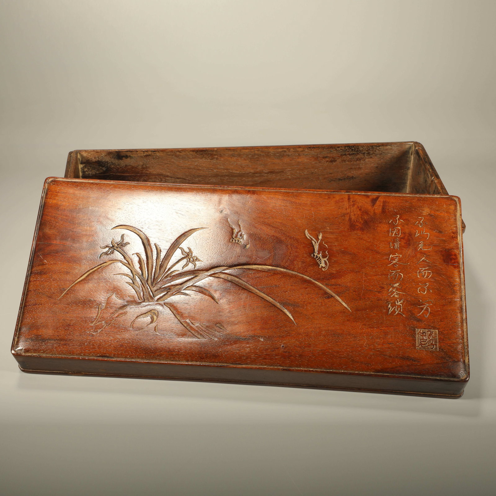 A HUANGHUALI BOX CARVED WITH ORCHID AND POEM INSCRIPTIONS: Huanghuali Box Carved with Orchid and Poem Inscriptions