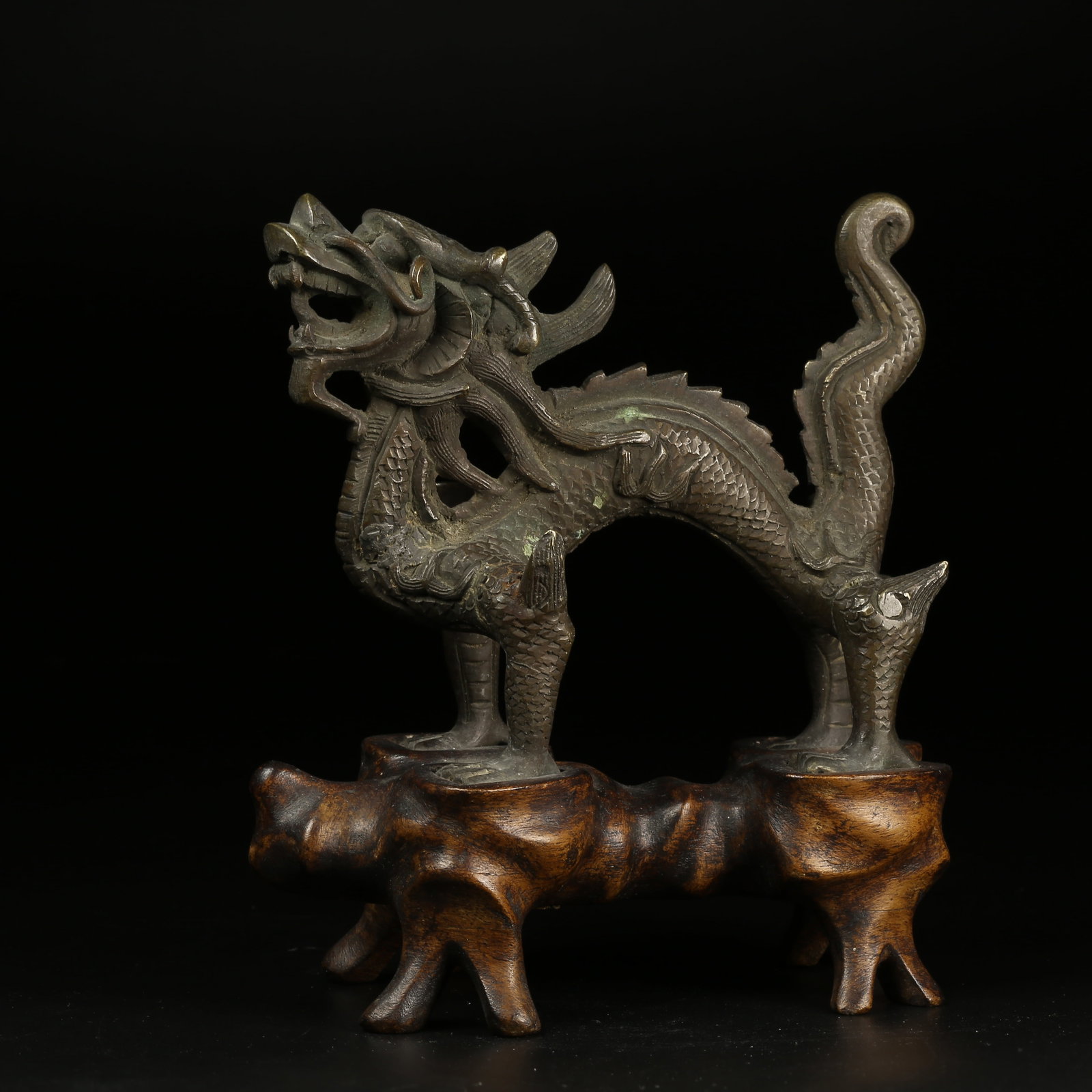 A BRONZE DRAGON-SHAPED ORNAMENT: Bronze Dragon-Shaped Ornament
