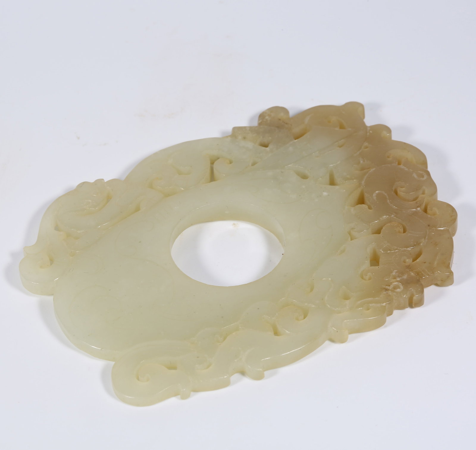 A ANCIENT JADE CHICKEN-HEART PENDANT WITH DRAGON AND PHOENIX MOTIF: Ancient Jade Chicken-Heart Pendant with Dragon and Phoenix Motif