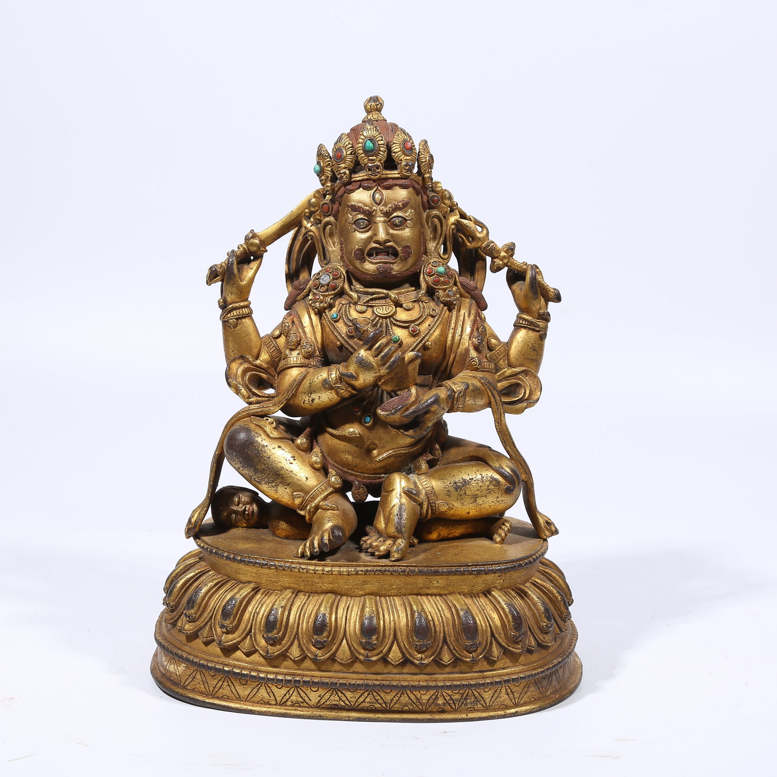 A GILT BRONZE FOUR-ARMED MAHAKALA STATUE: Gilt Bronze Four-Armed Mahakala Statue