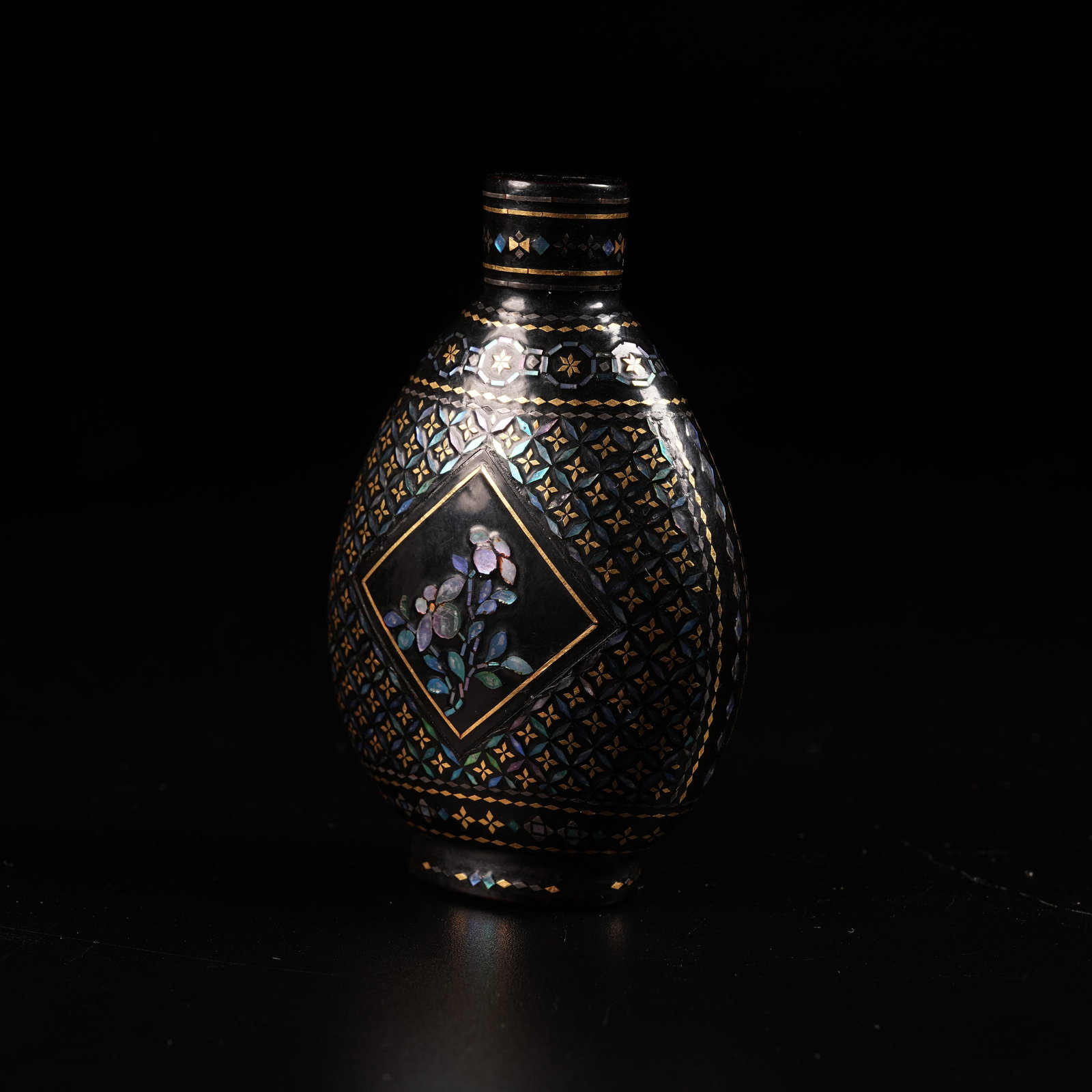 A WOODEN SNUFF BOTTLE WITH MOTHER-OF-PEARL INLAY AND FLORAL MOTIF: Wooden Snuff Bottle with Mother-of-Pearl Inlay and Floral Motif